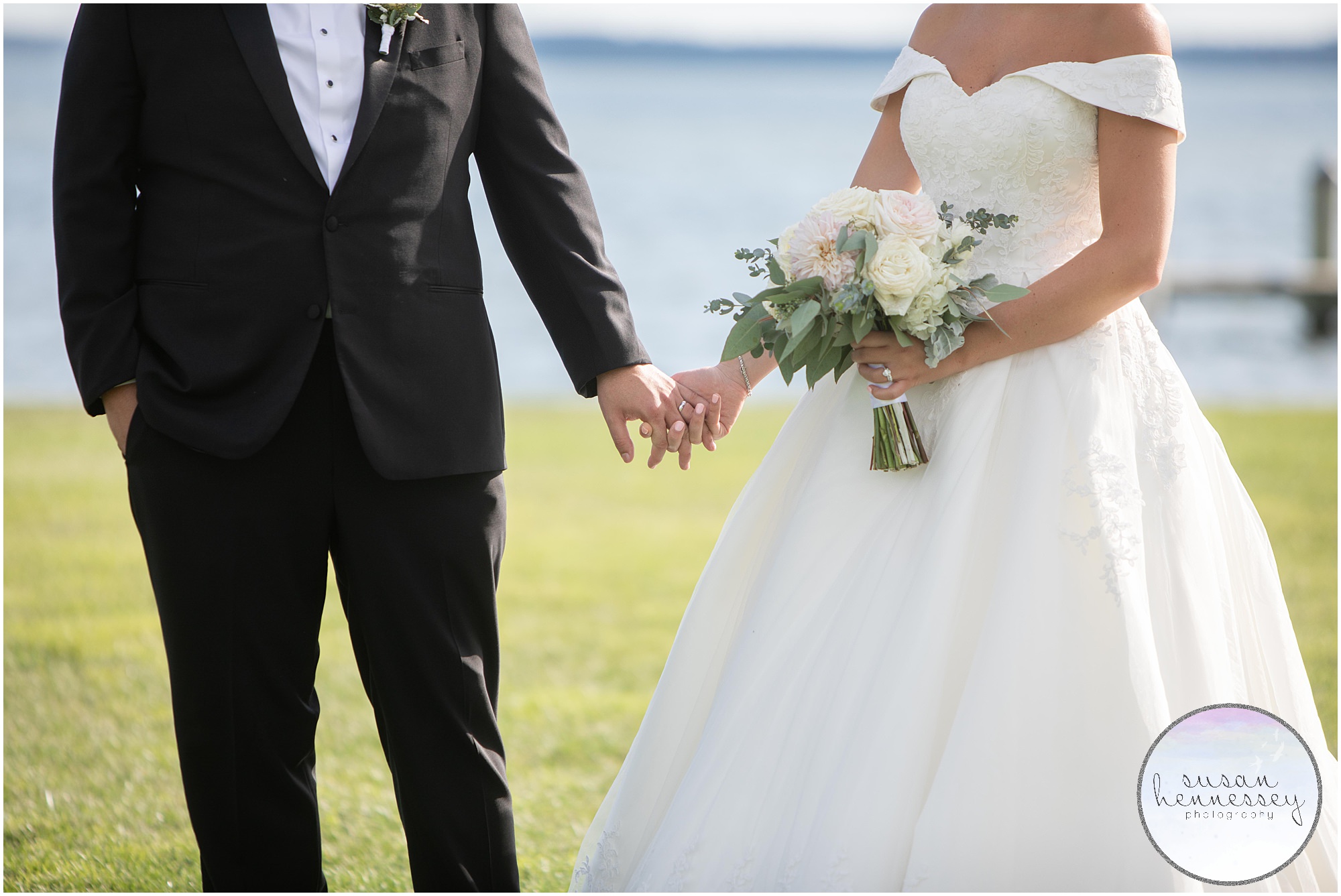 Detail of bride's bouquet while couple holds hands