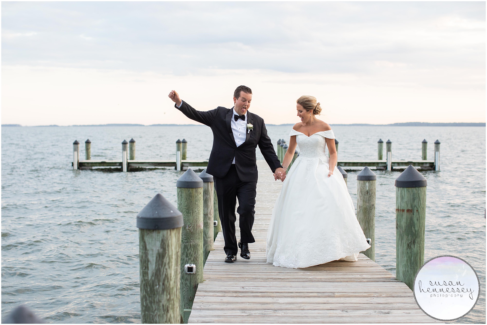 Couple on pier at waterfront wedding