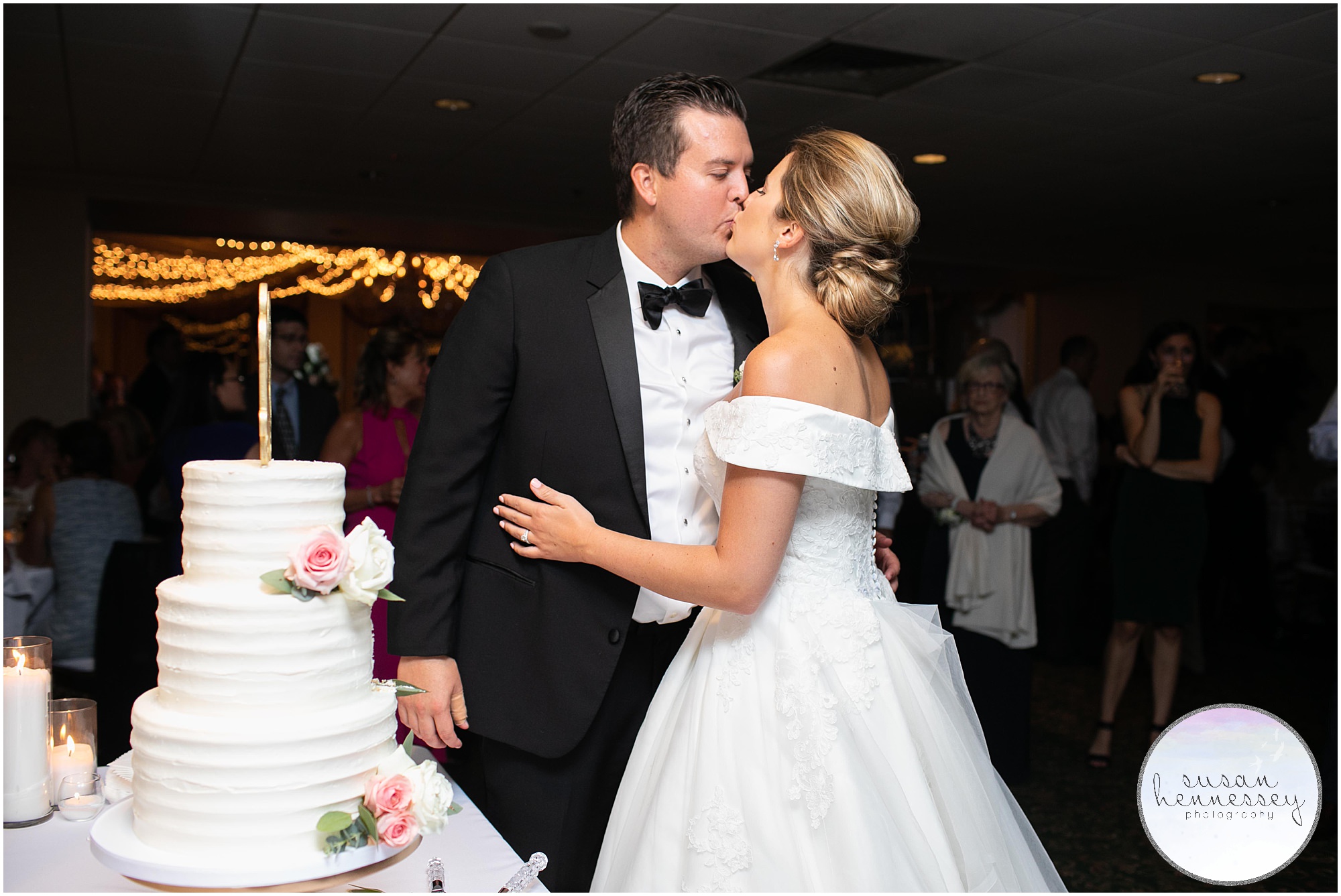 Bride and groom in front of cake at rehoboth beach country club wedding
