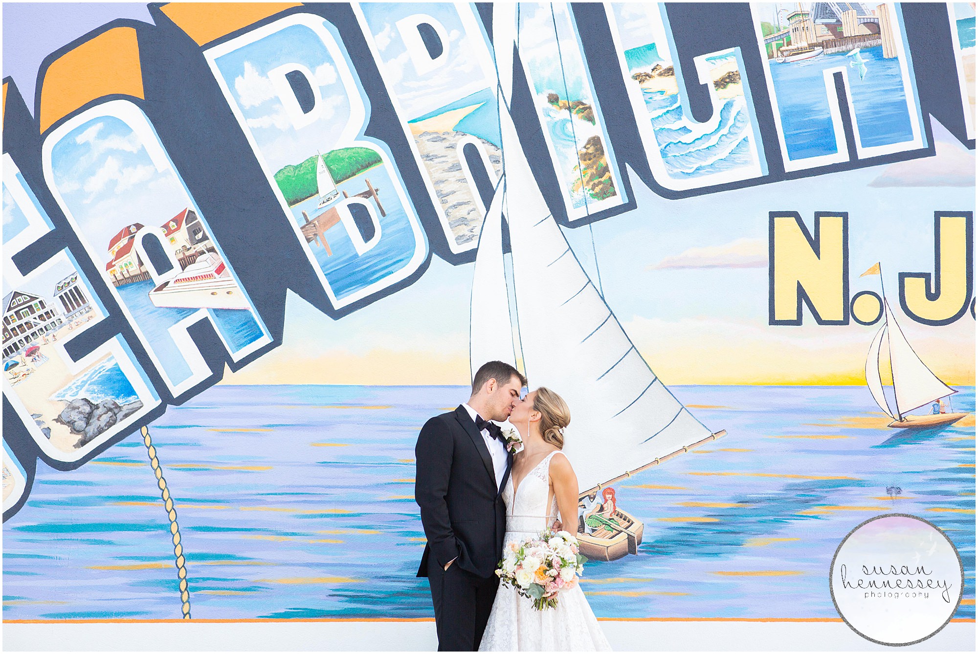 A bride and groom pose at the Welcome to Sea Bright mural on their wedding day