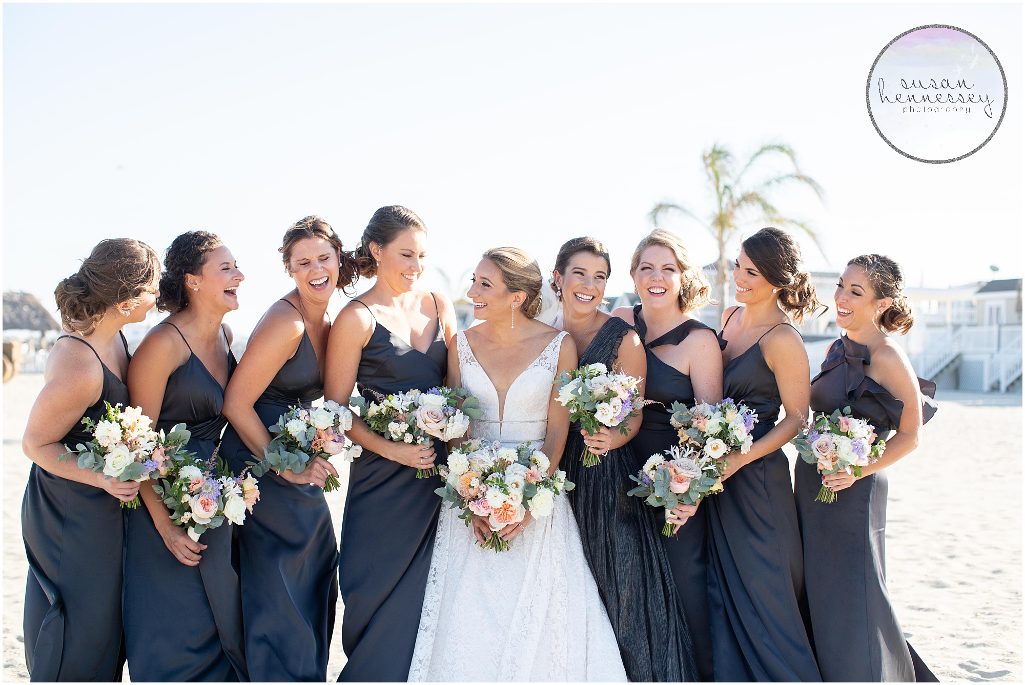 Bride and bridesmaids laugh in Sea Bright, NJ