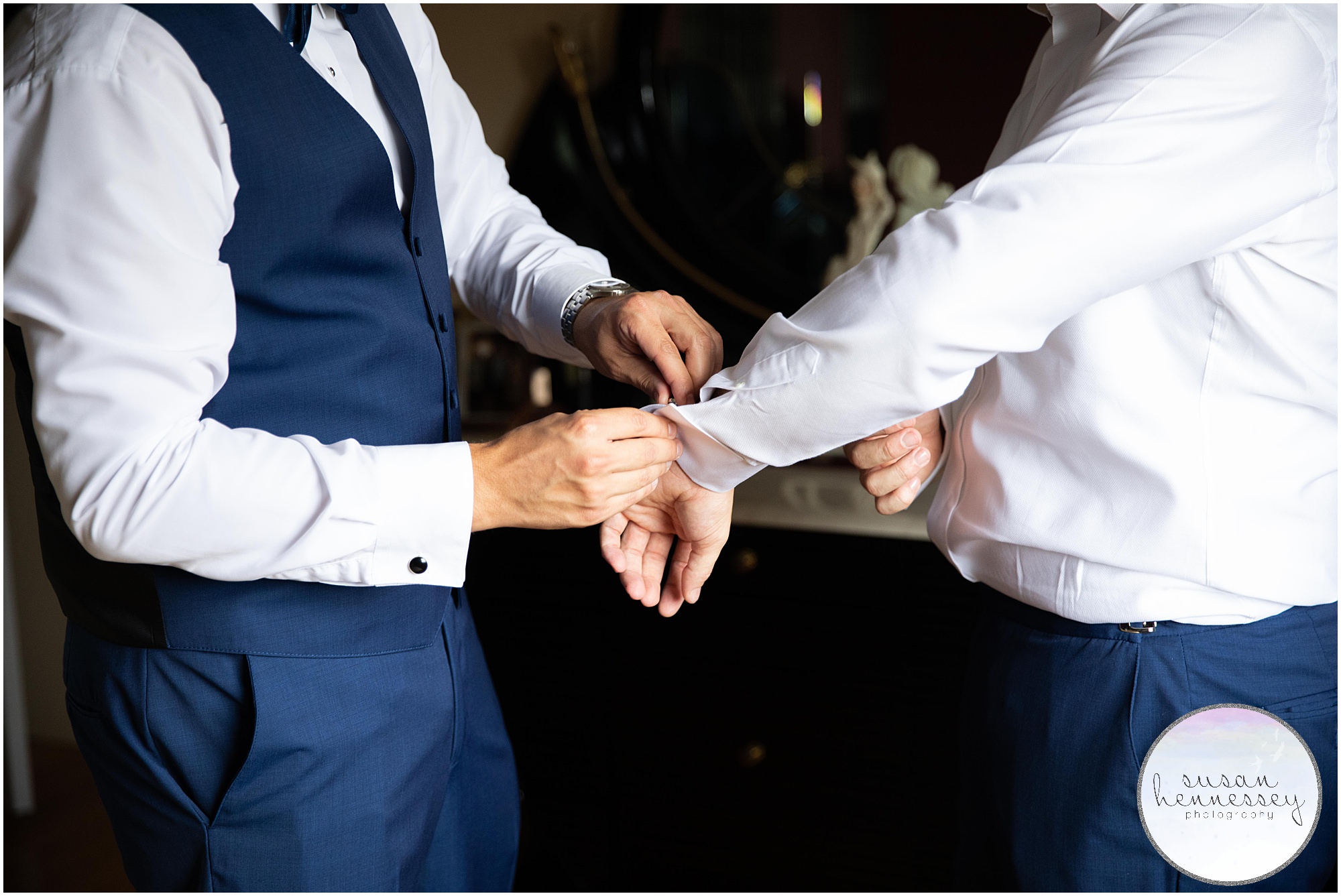 Best man helps with groom's cuff links for Hamilton Manor wedding