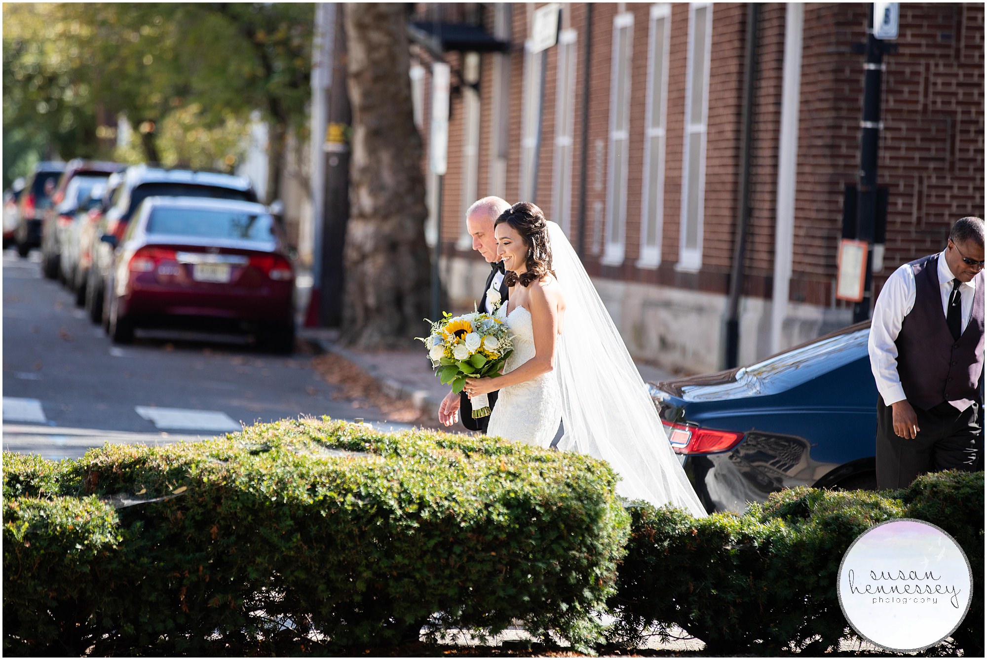 Bride walks to church from sedan with her father