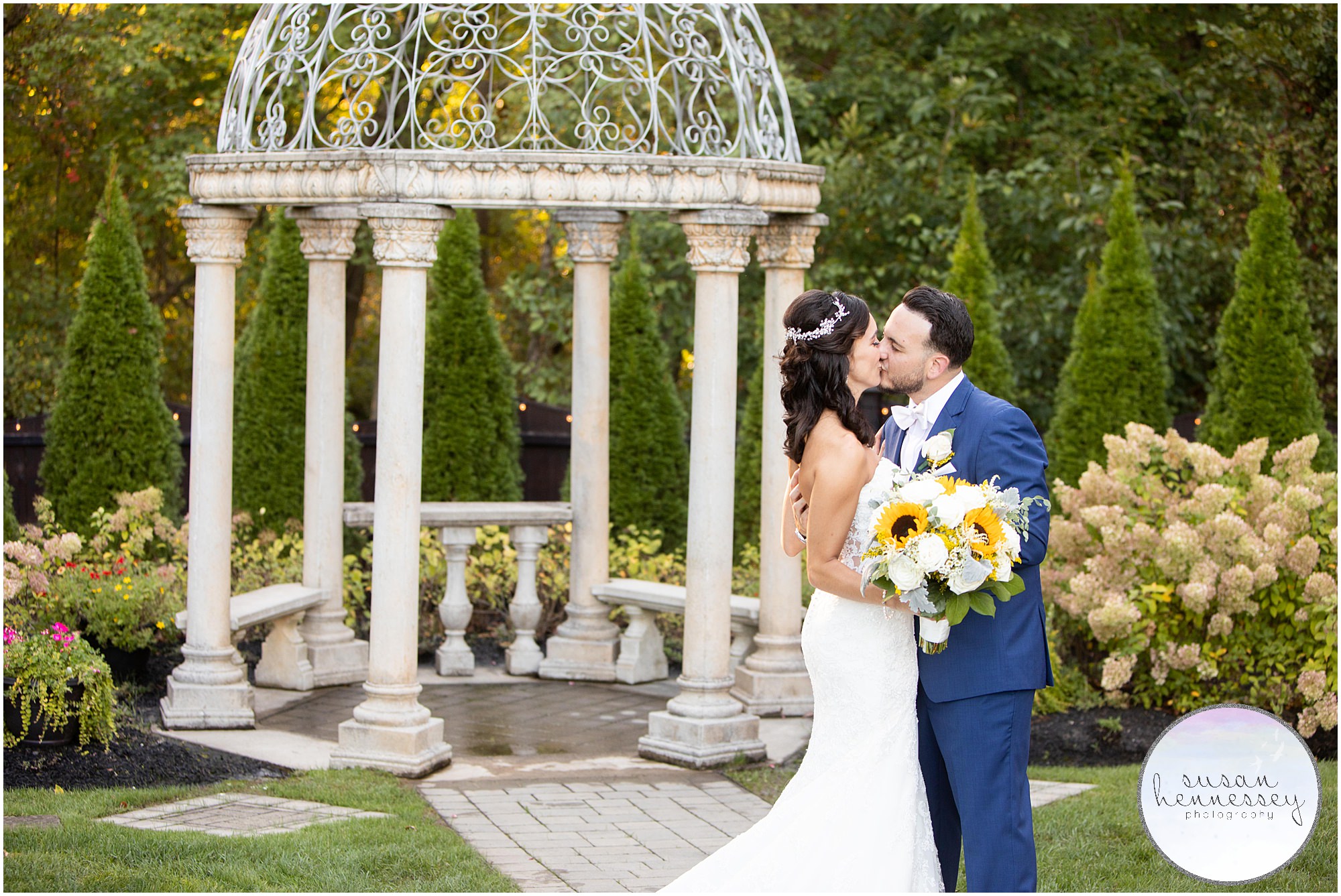 Bride and groom kiss at their September wedding at the Hamilton Manor
