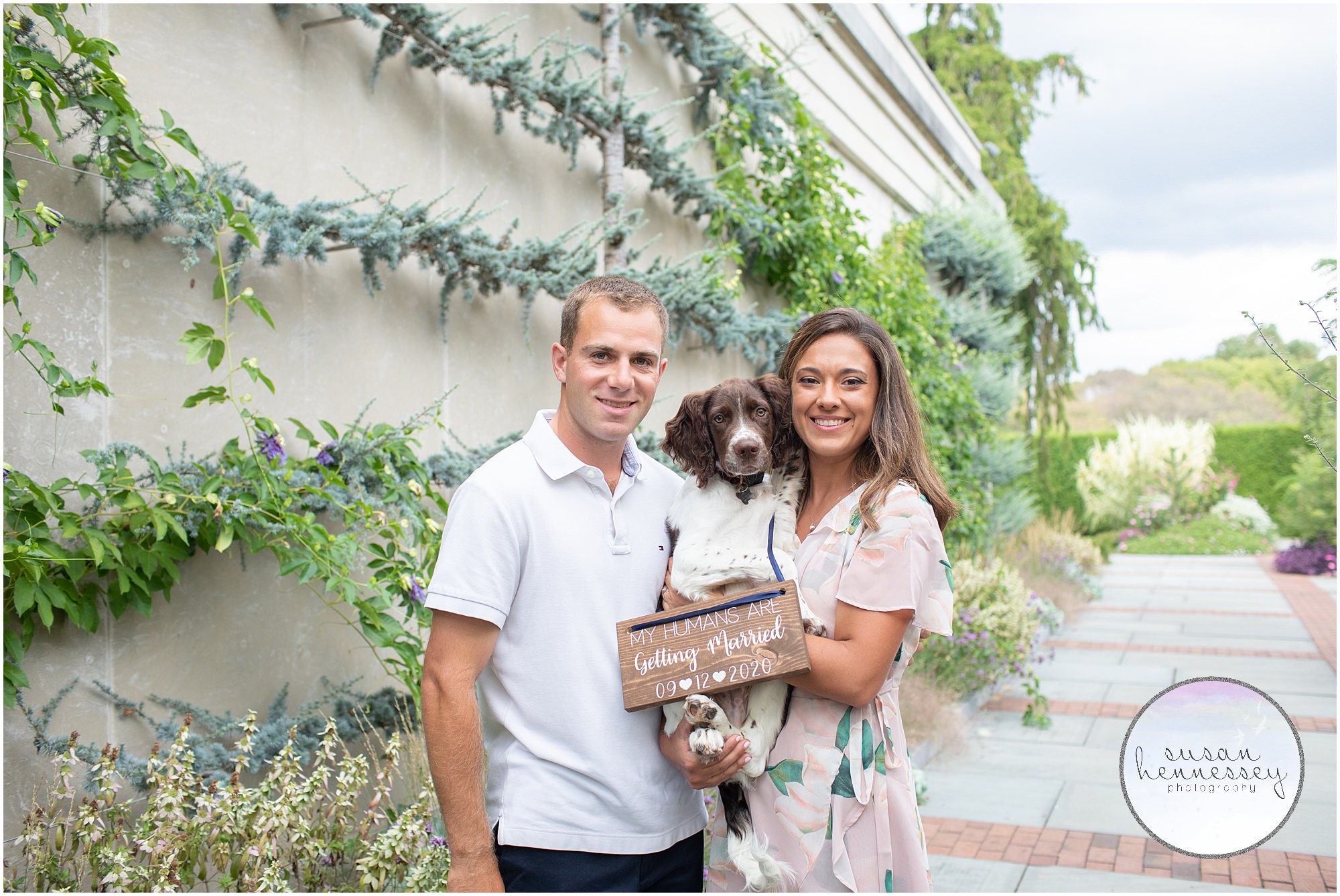 An engaged couple pose with their dog at their Philadelphia engagement session.