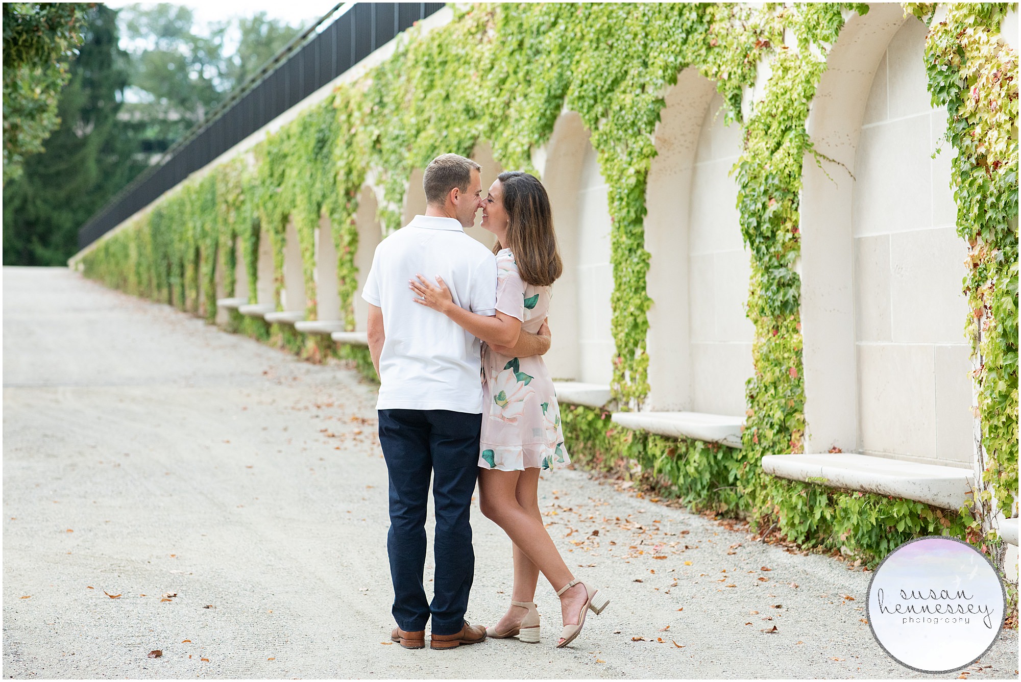 A couple pose in front of the ivy at Longwood gardens