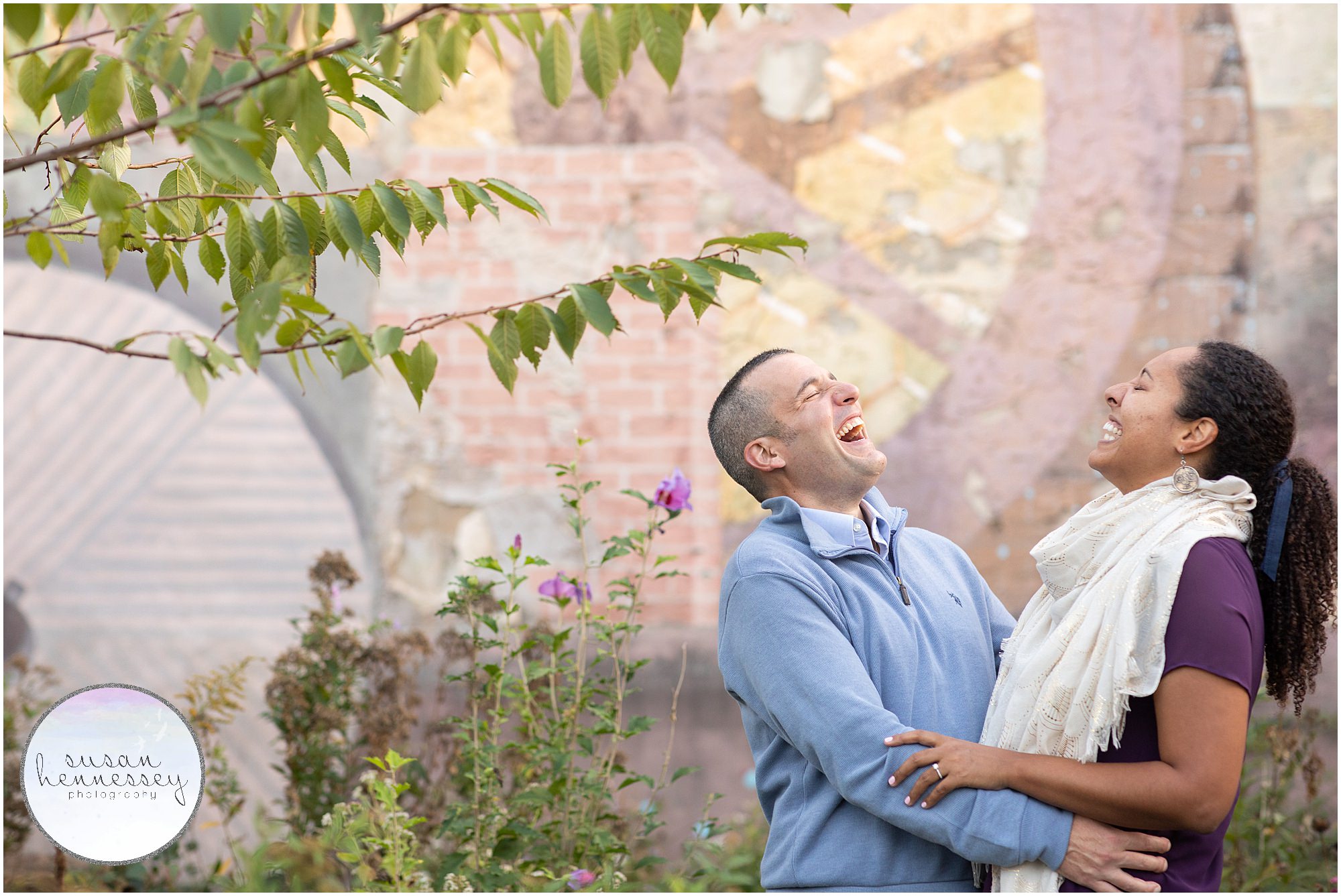 A couple laugh at their Philly engagement session
