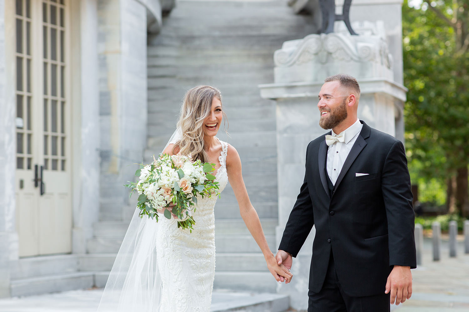 A happy bride and groom laugh at their Philadelphia wedding