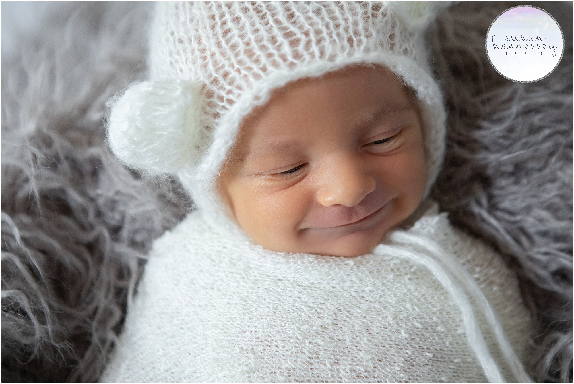 Baby boy smiles in his South Jersey newborn photography session