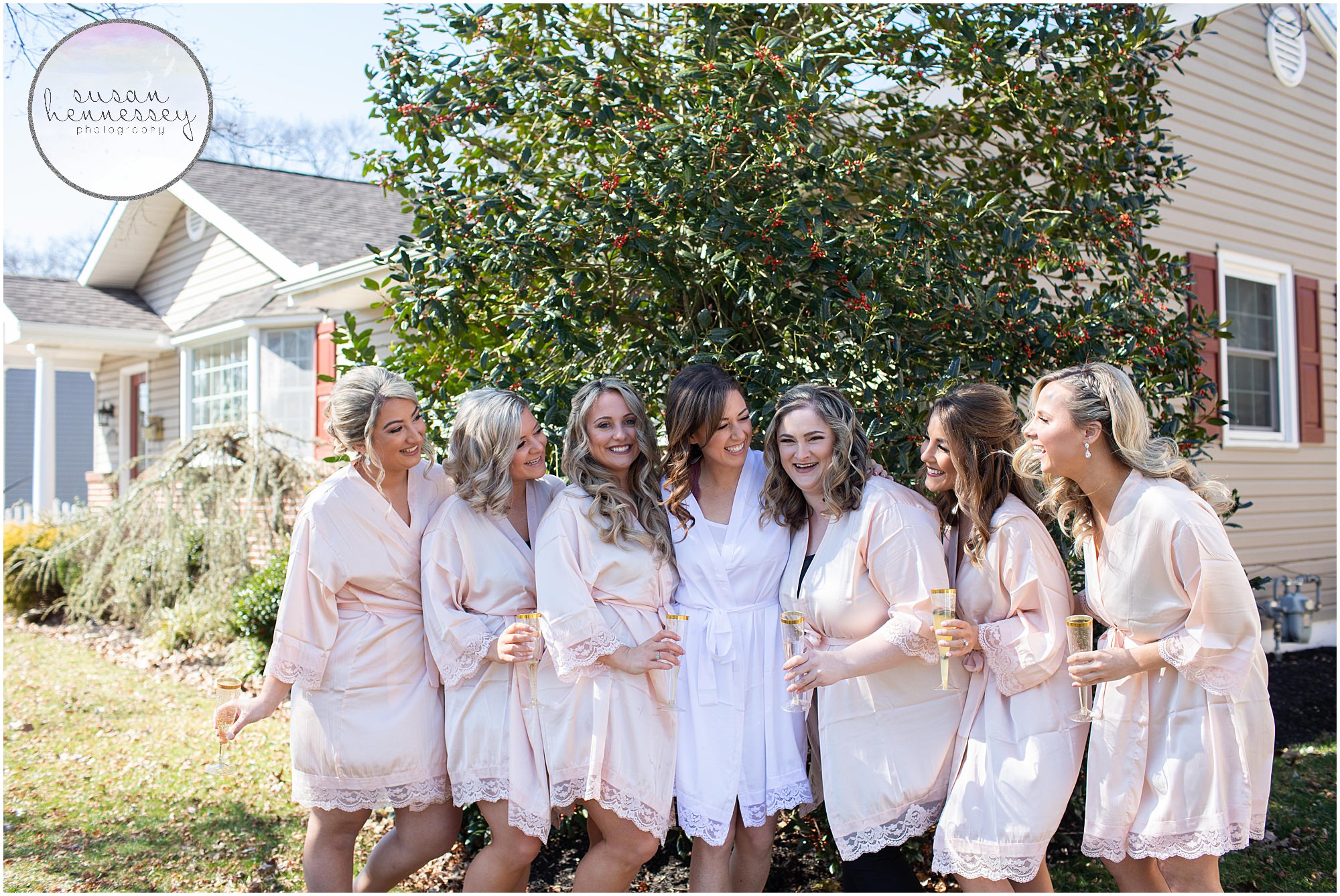 Bride and bridesmaids sip champagne in matching robes