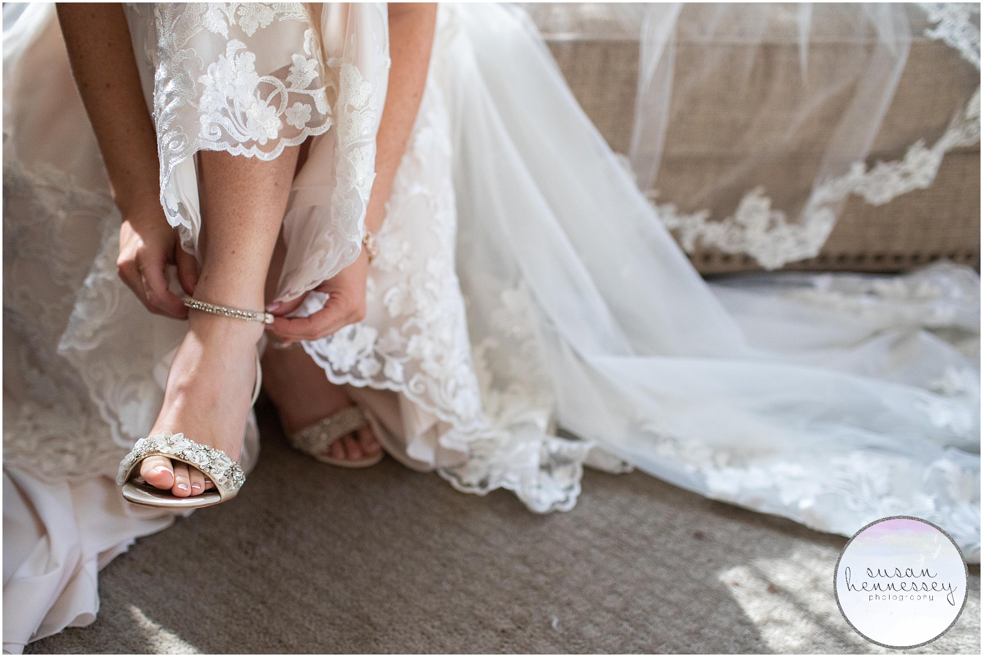 A bride puts on her Badgley Mischka shoes at winter wedding