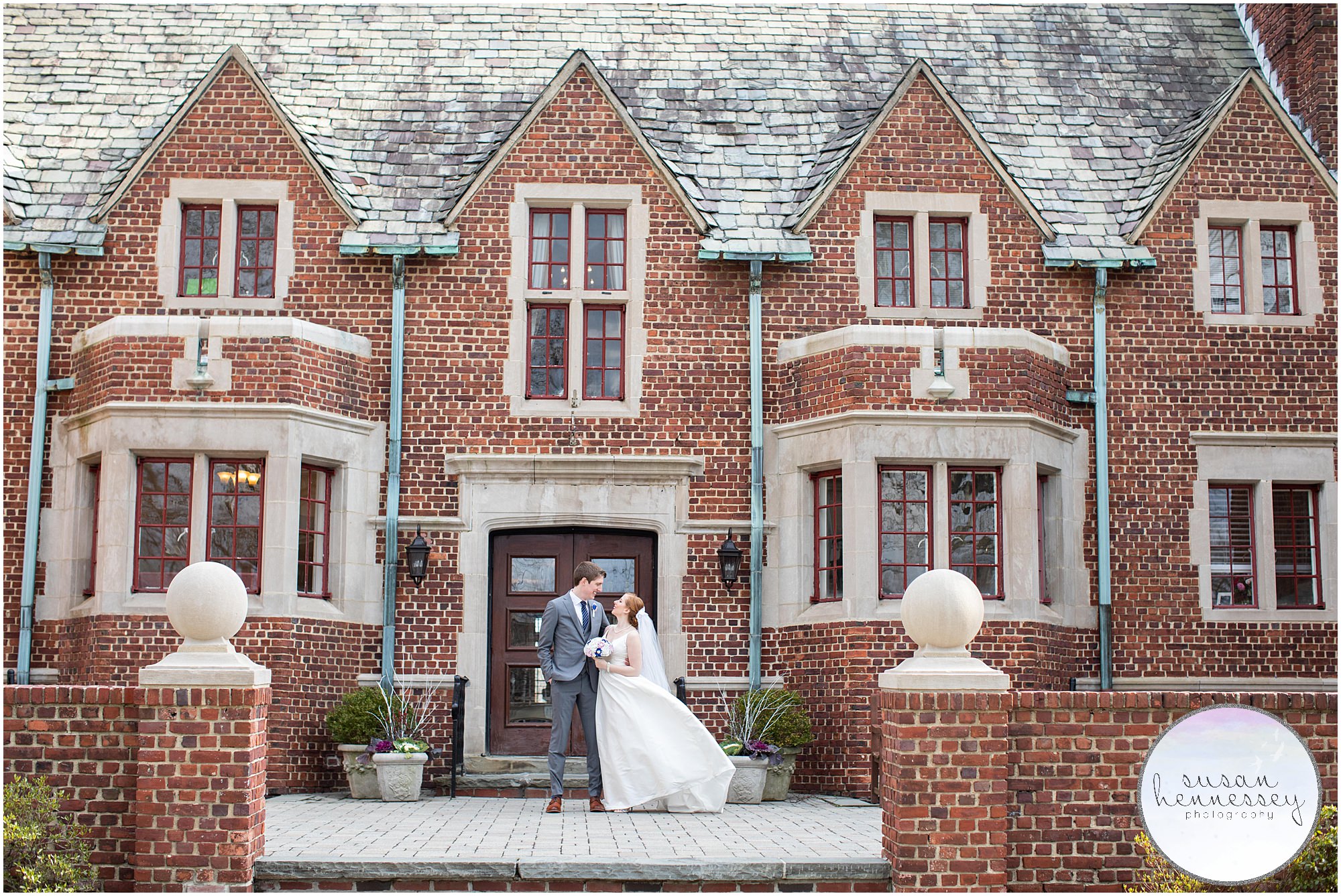 A happy bride and groom in front of the Moorestown Community House