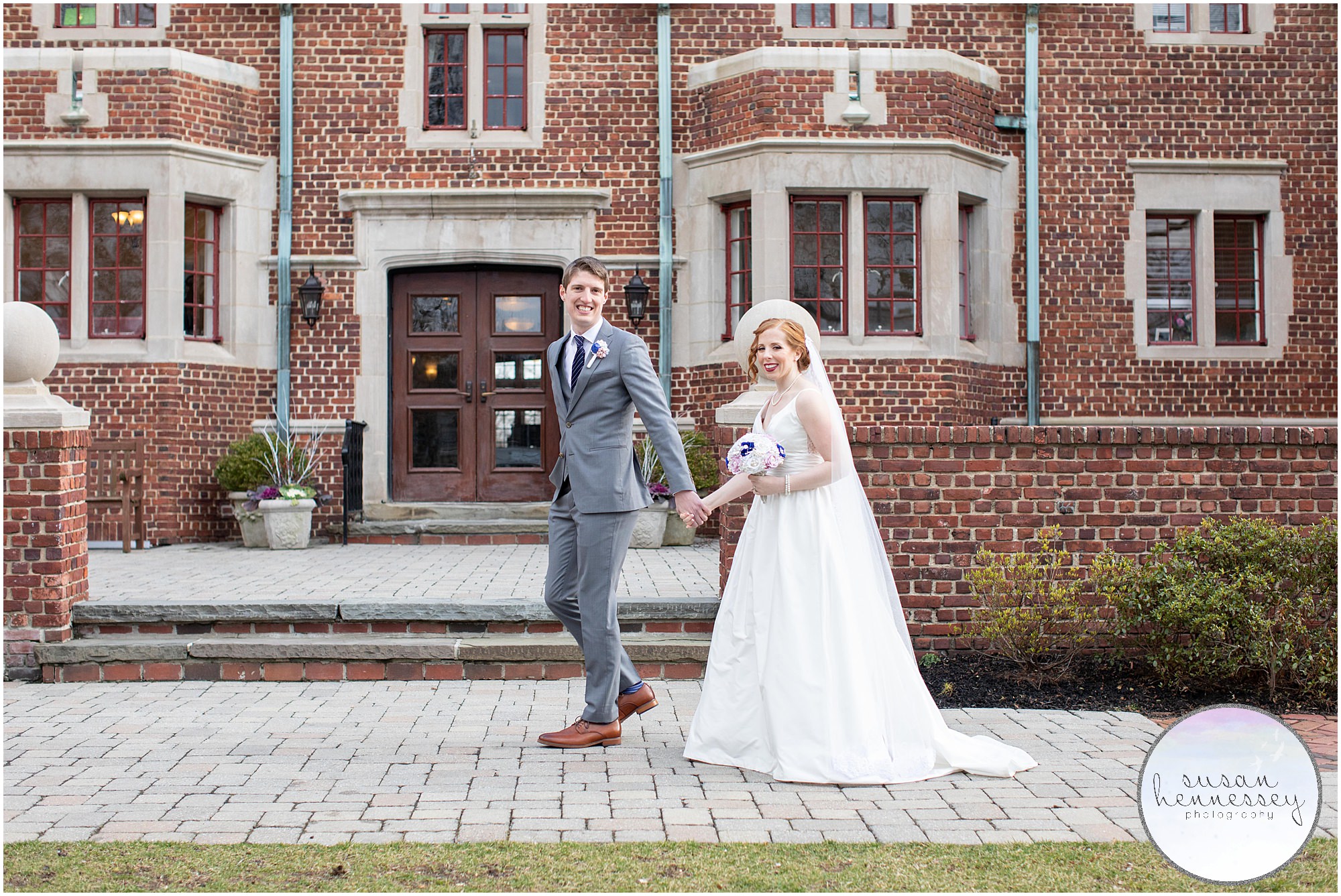 Bride and groom walk in front of the Moorestown Community House