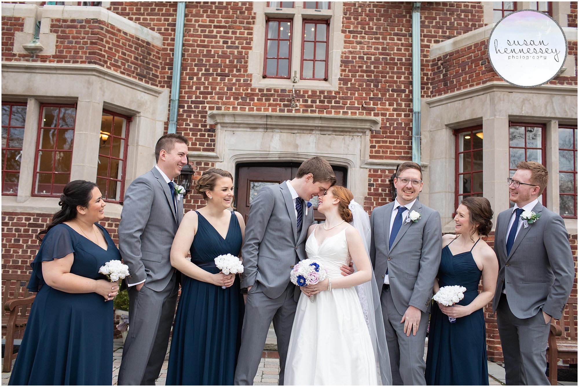 A fun bridal party in navy blue and gray at winter wedding