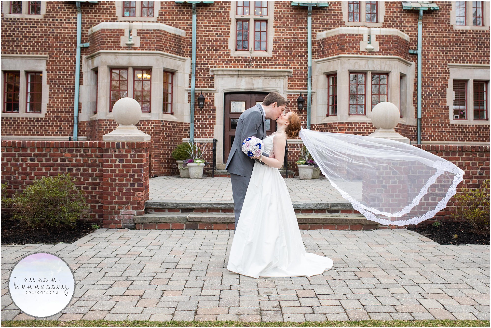 The bride's veil blows in the wind at Moorestown Community House wedding