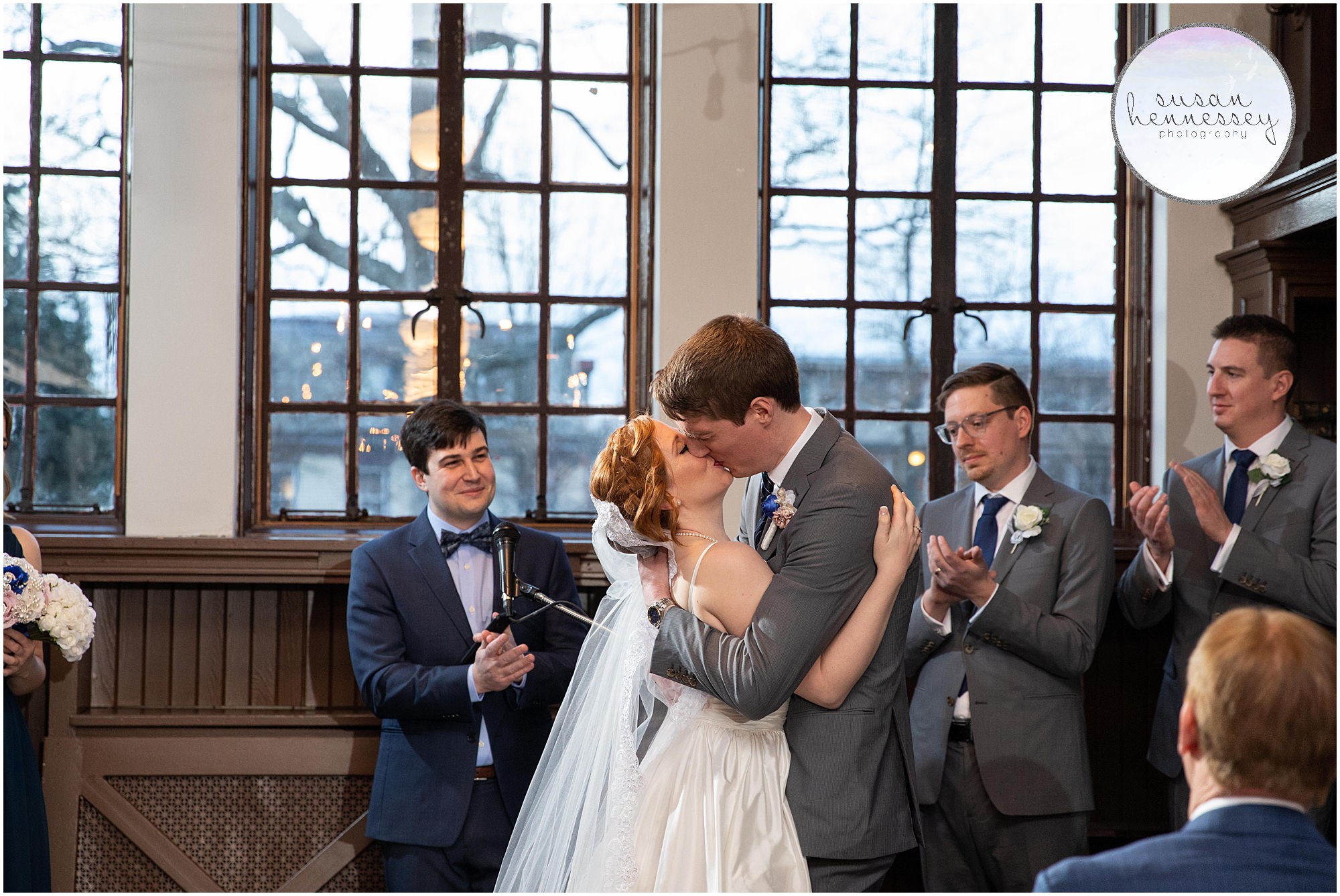 bride and groom share first kiss at indoor ceremony in Moorestown, NJ