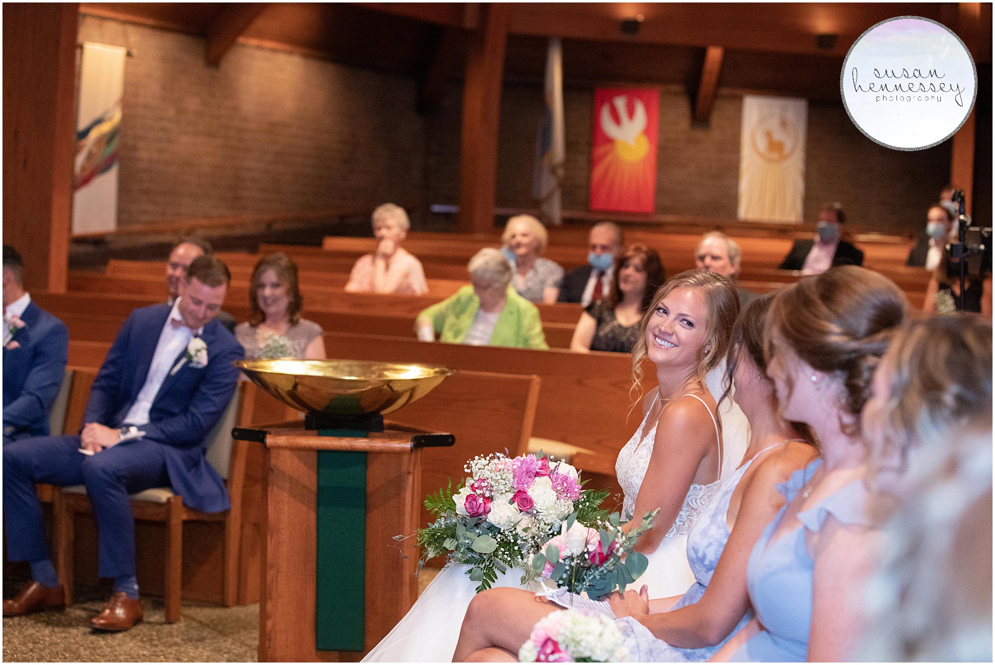 bride and groom sit at church