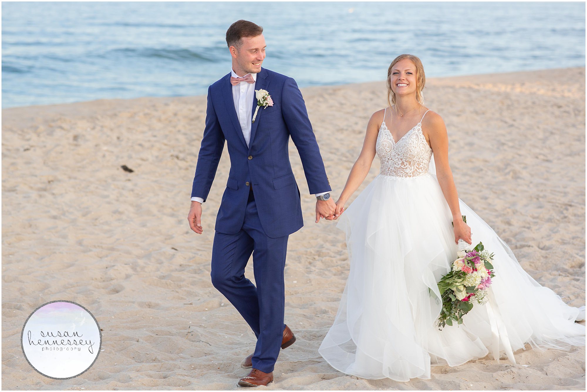 Happy couple on beach for couple portraits at wedding