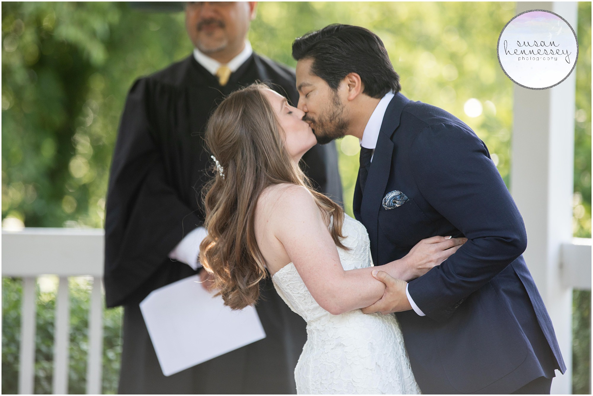 Bride and groom kiss at their intimate wedding ceremony at Sayen Gardens