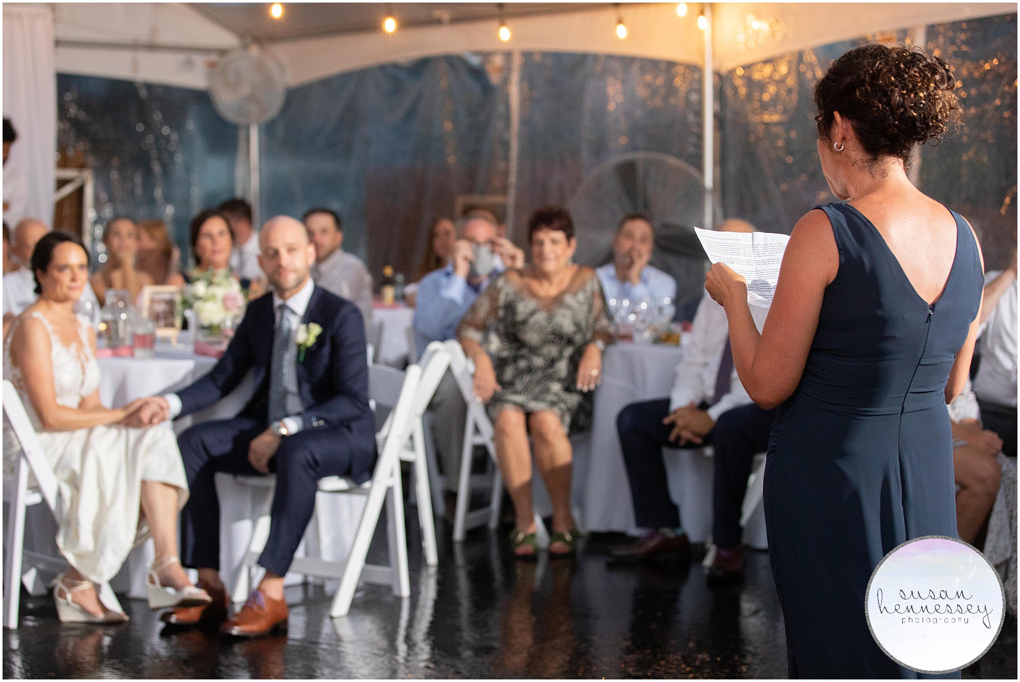 Maid of honor gives speech at summer tented wedding