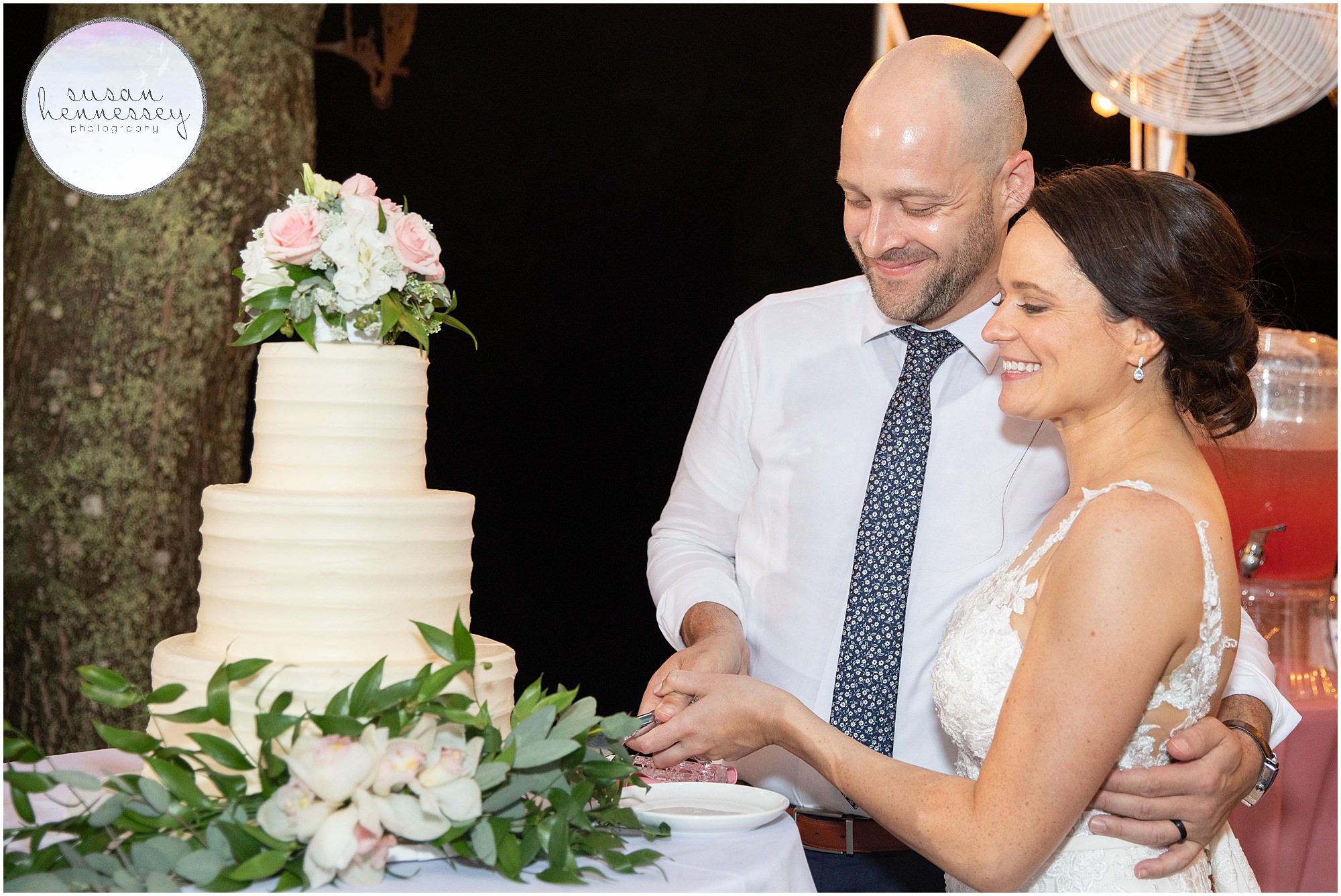 Bride and groom cut the cake at outdoor backyard wedding