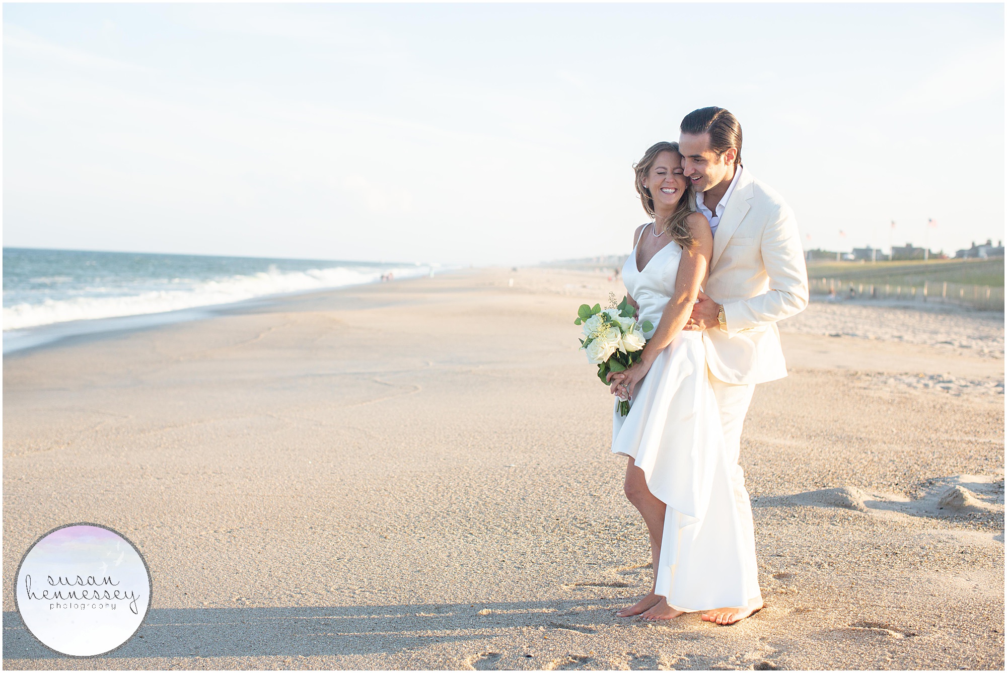 A bride and groom pose near the ocean at their South Jersey microwedding