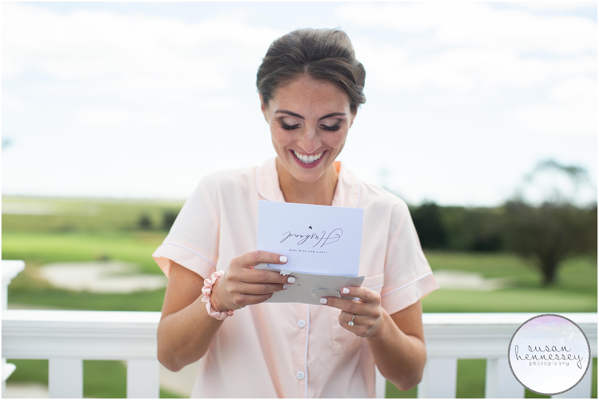 A bride reads the letter from the groom on the sky deck of Atlantic City Country Club