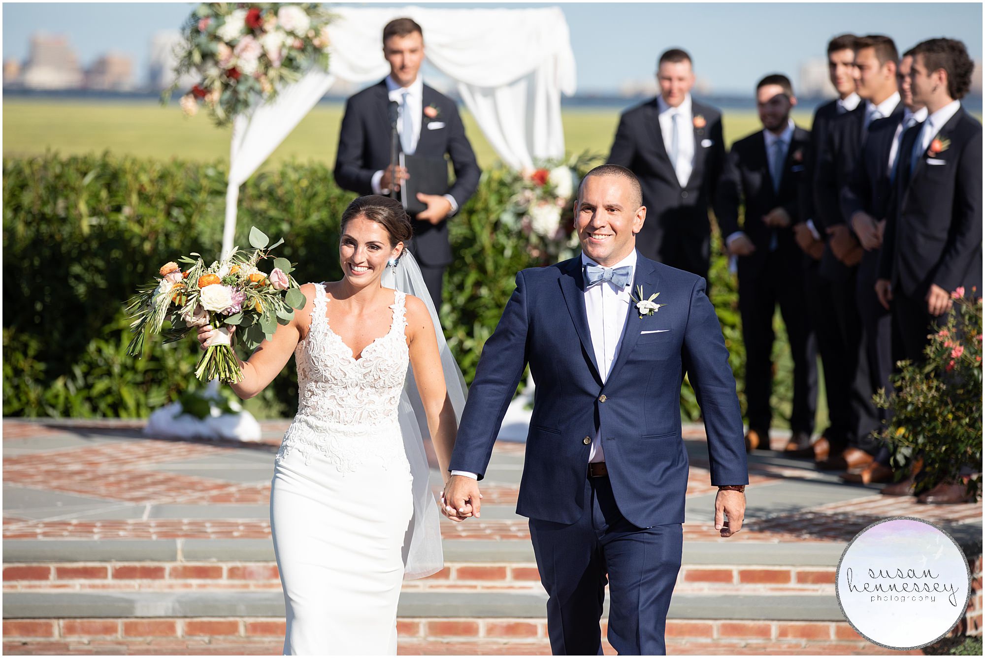 Bride and groom walk down aisle after getting married at an outdoor ceremony at Atlantic City Country Club
