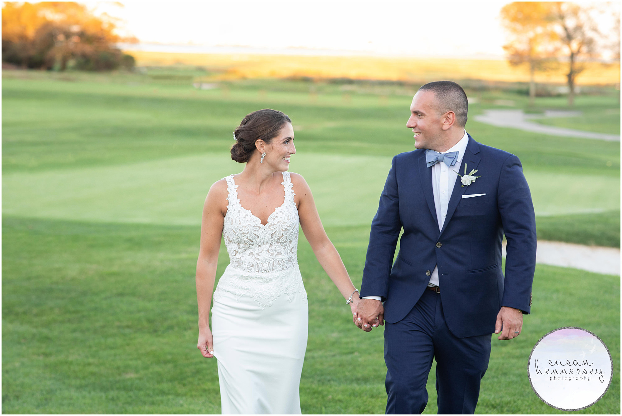 Bride and groom walk on golf course at Atlantic City Country Club