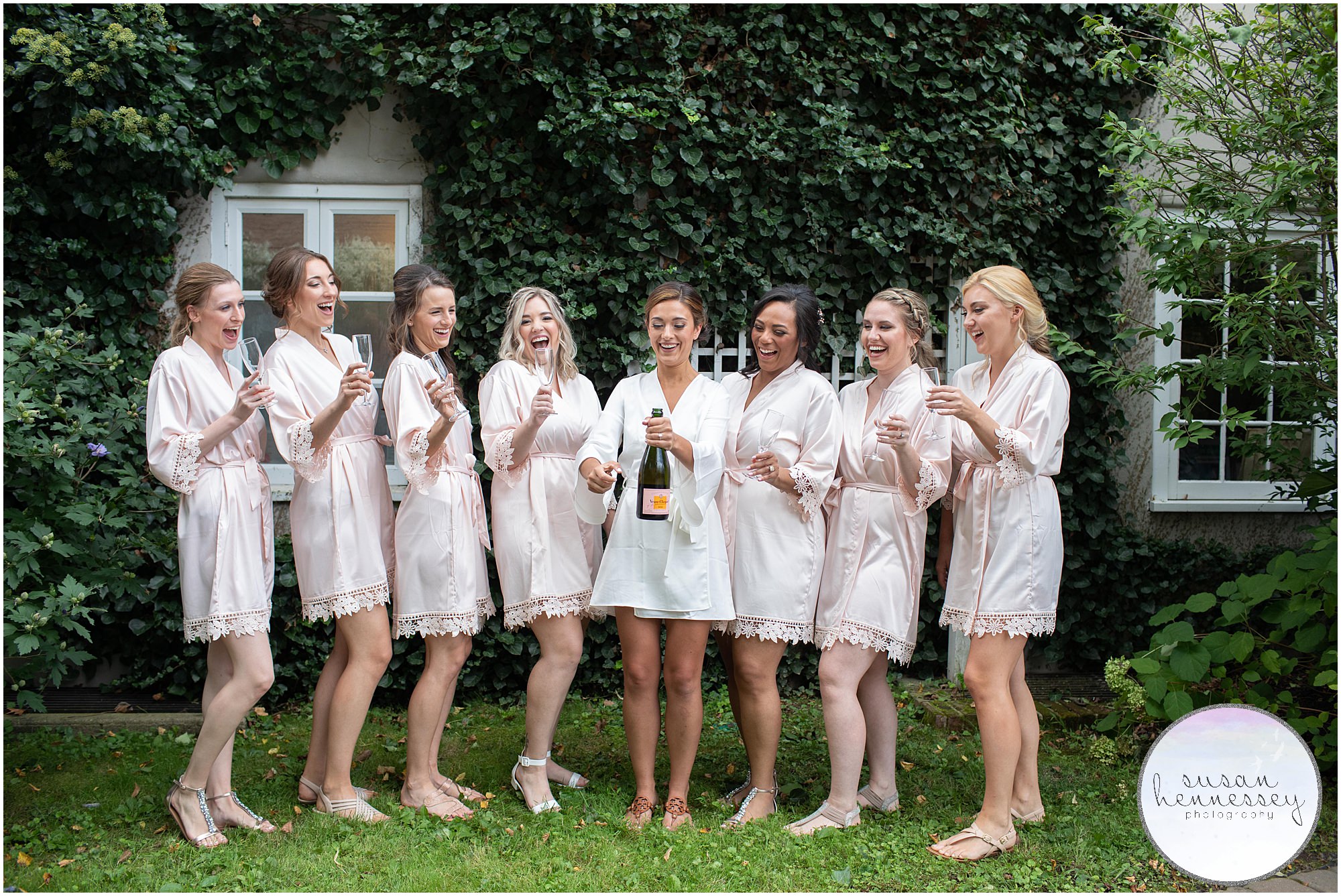 Bride and bridesmaids pop champagne