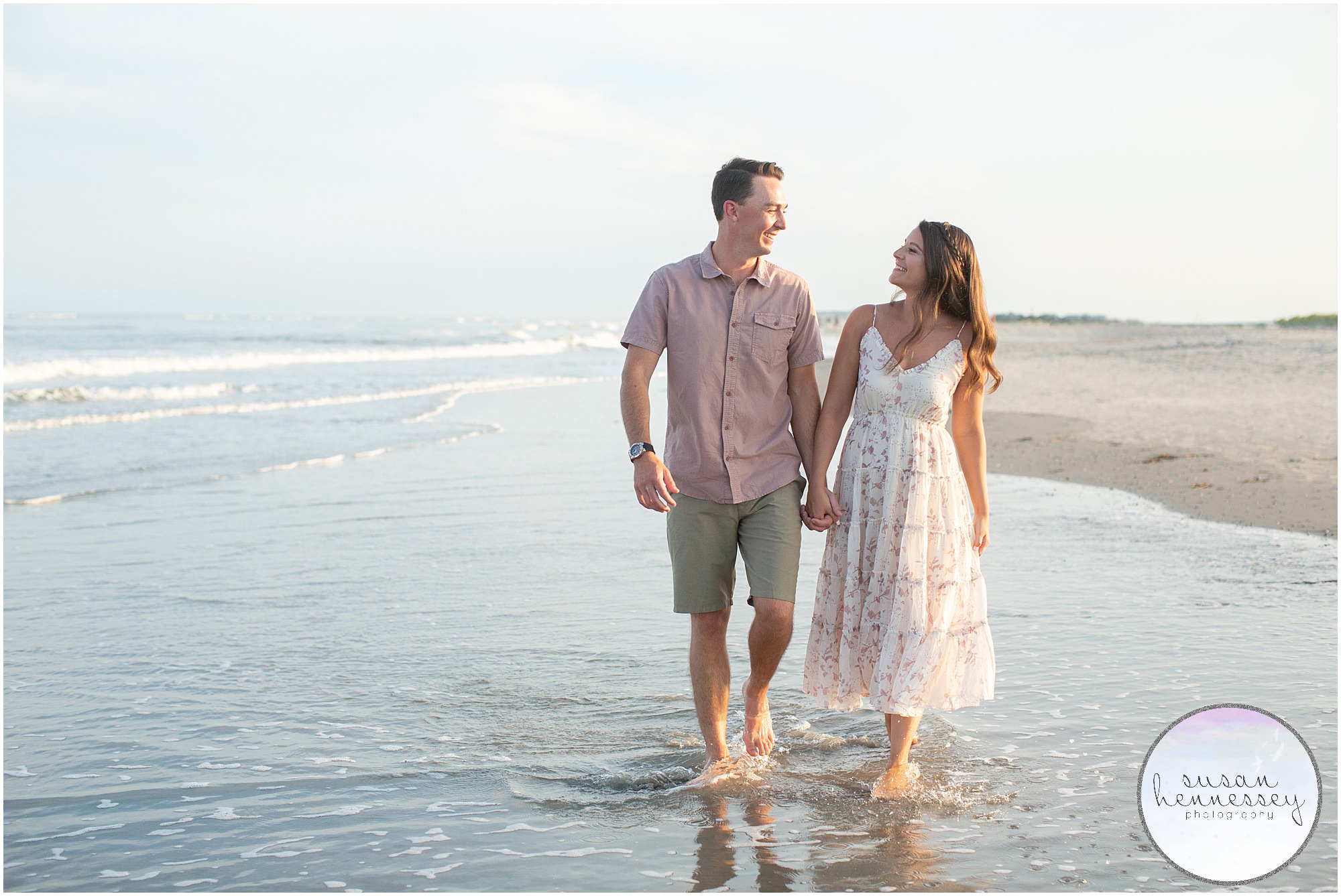 A couple walk in the water at their Corson's Inlet Engagement Session