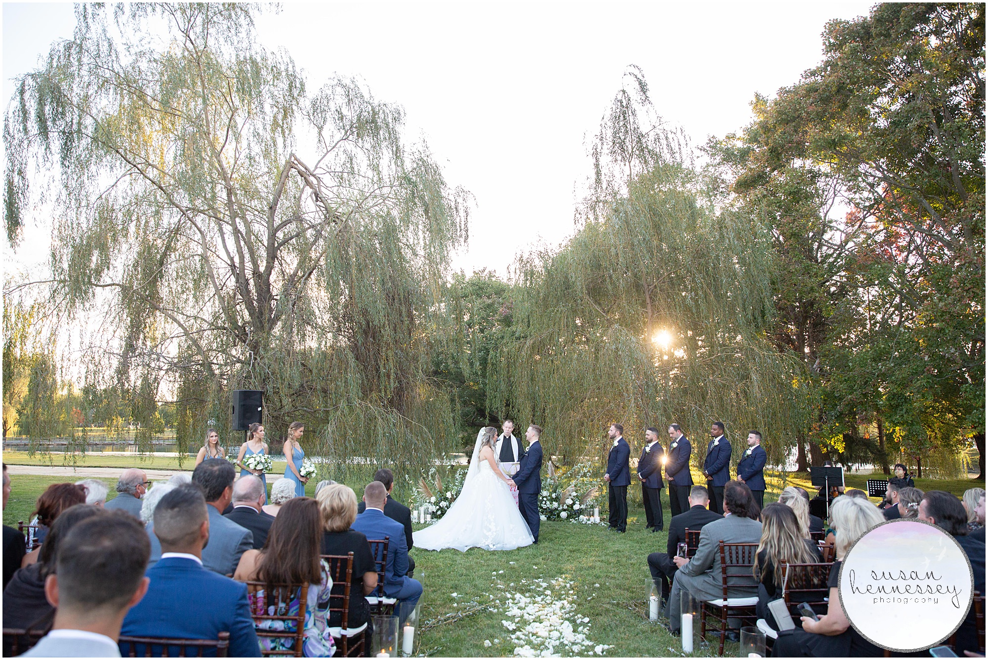 Ceremony in the willow trees during sunset at Windows on the Water at Frogbridge Wedding