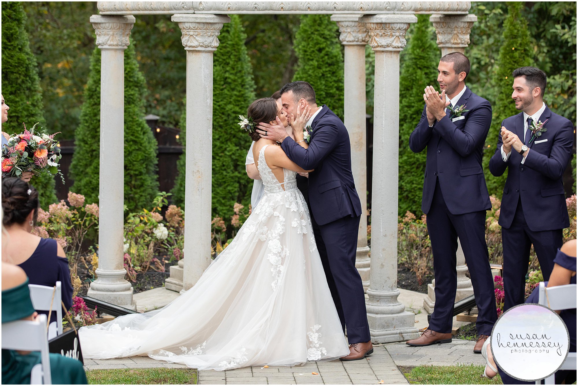 Bride and groom kiss at The Hamilton Manor wedding ceremony