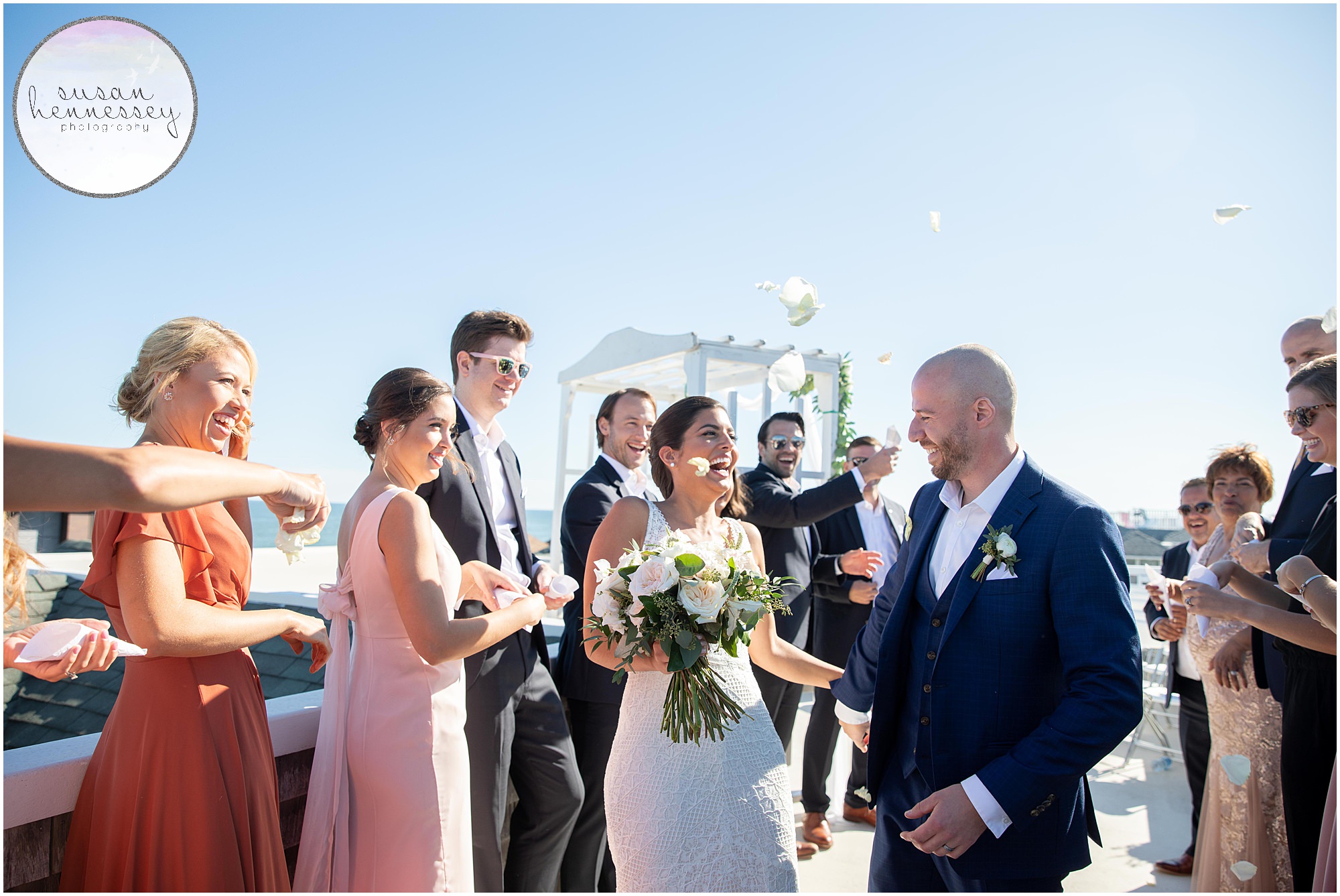 Bride and groom laugh during petal toss at Long Beach Island Microwedding