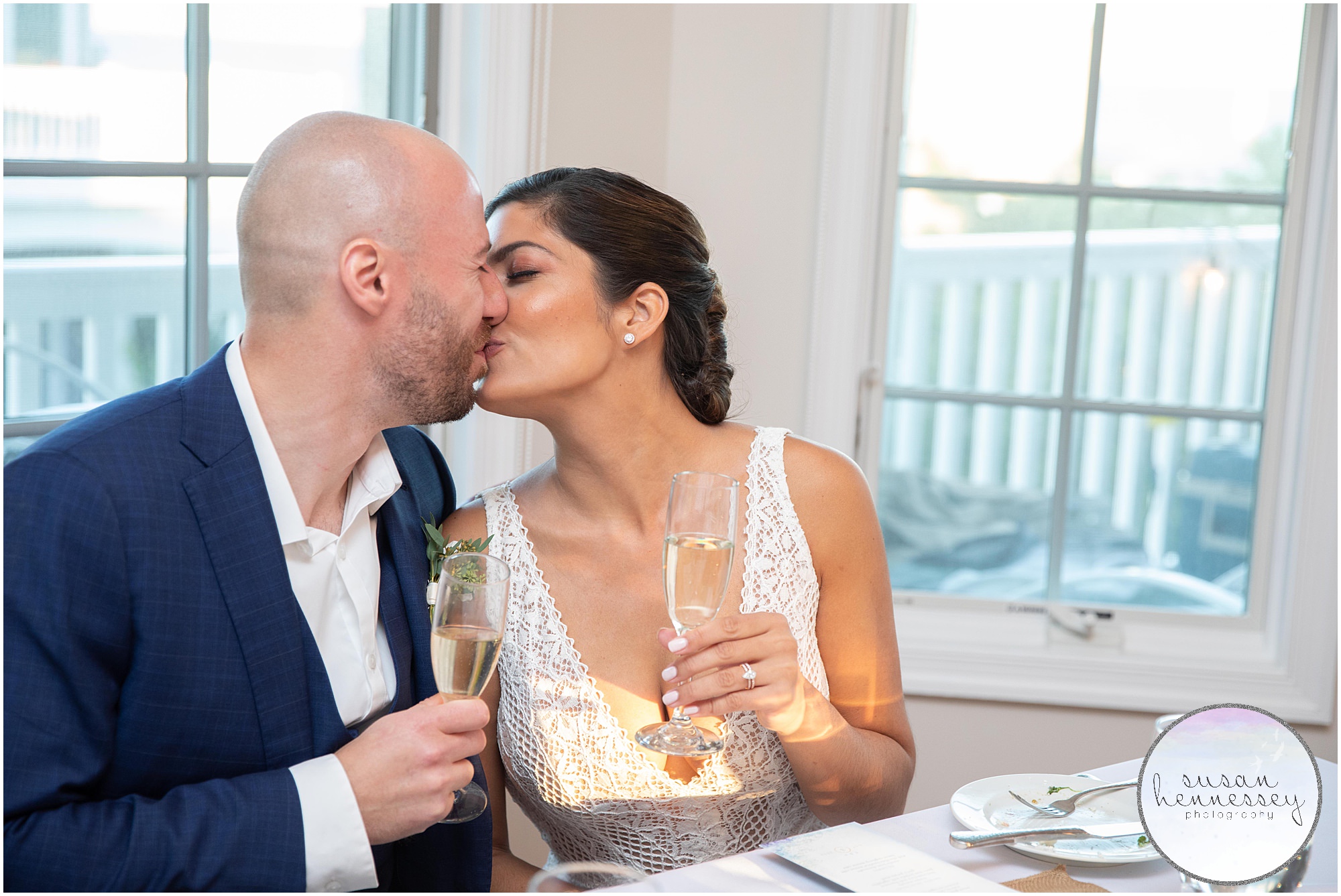 A couple who were just married share a kiss and champagne