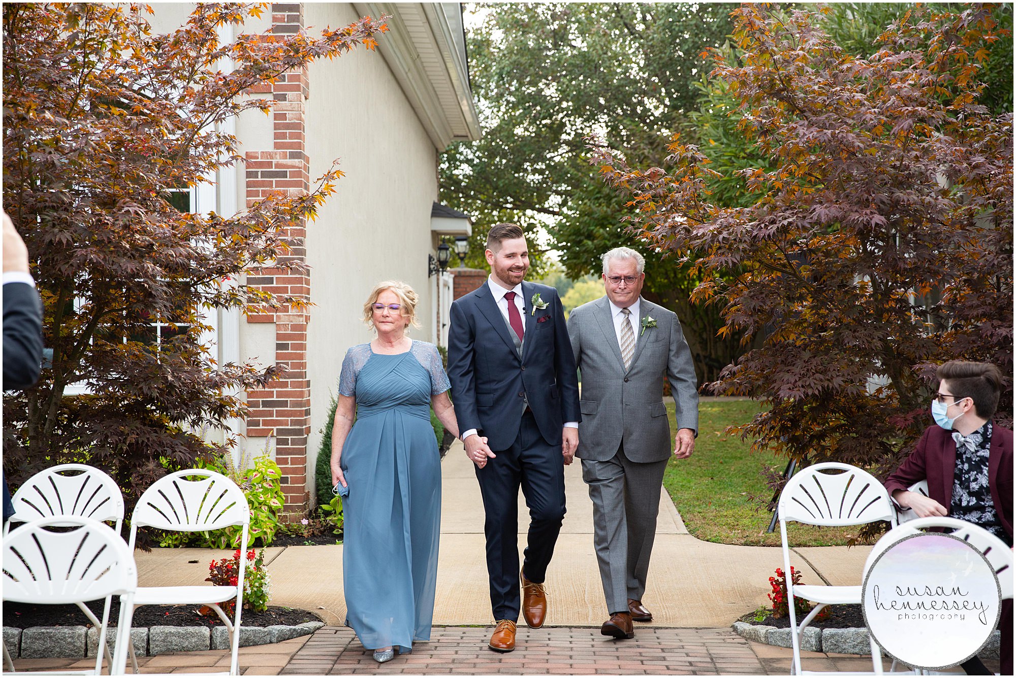 Groom and parents walk down aisle at Wedding at Old York Country Club