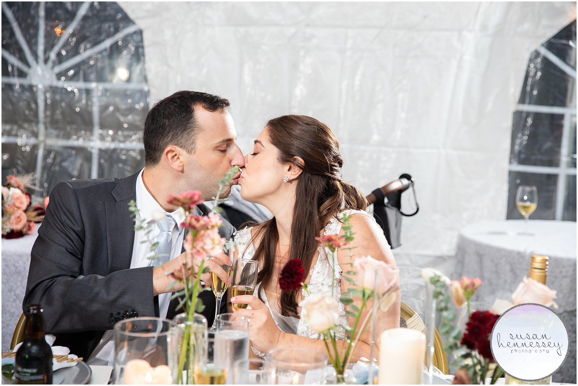 Couple kiss at table at microwedding at Andre's Lakeside Dining