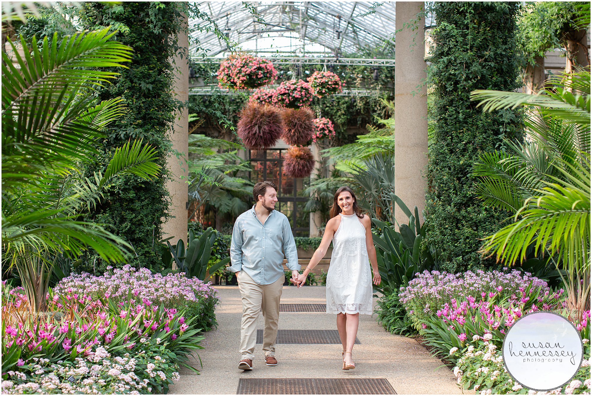 A happily engaged couple at their engagement session at longwood gardens