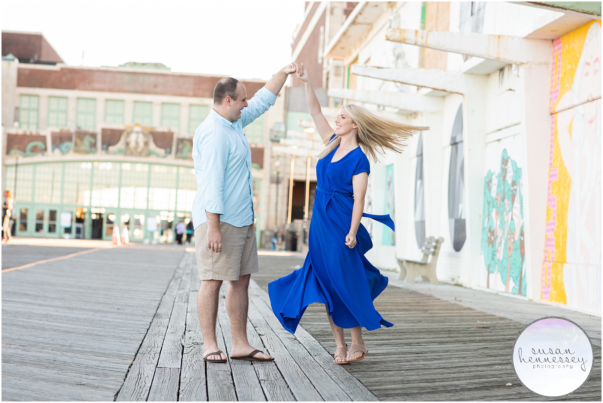 Engagement Session at Asbury Park, groom to be twirls bride to be. 
