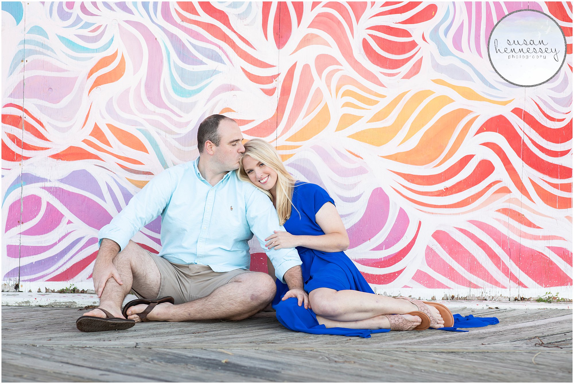 Engagement Session at Asbury Park with engaged couple sitting in front of mural