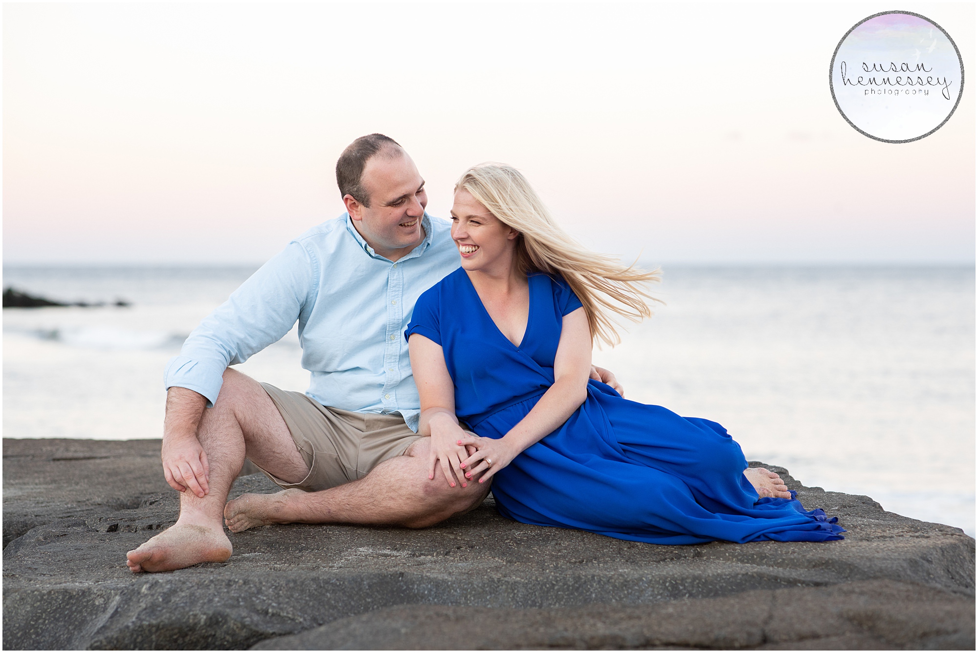 Happily engaged couple on the rocks at their Engagement Session at Asbury Park