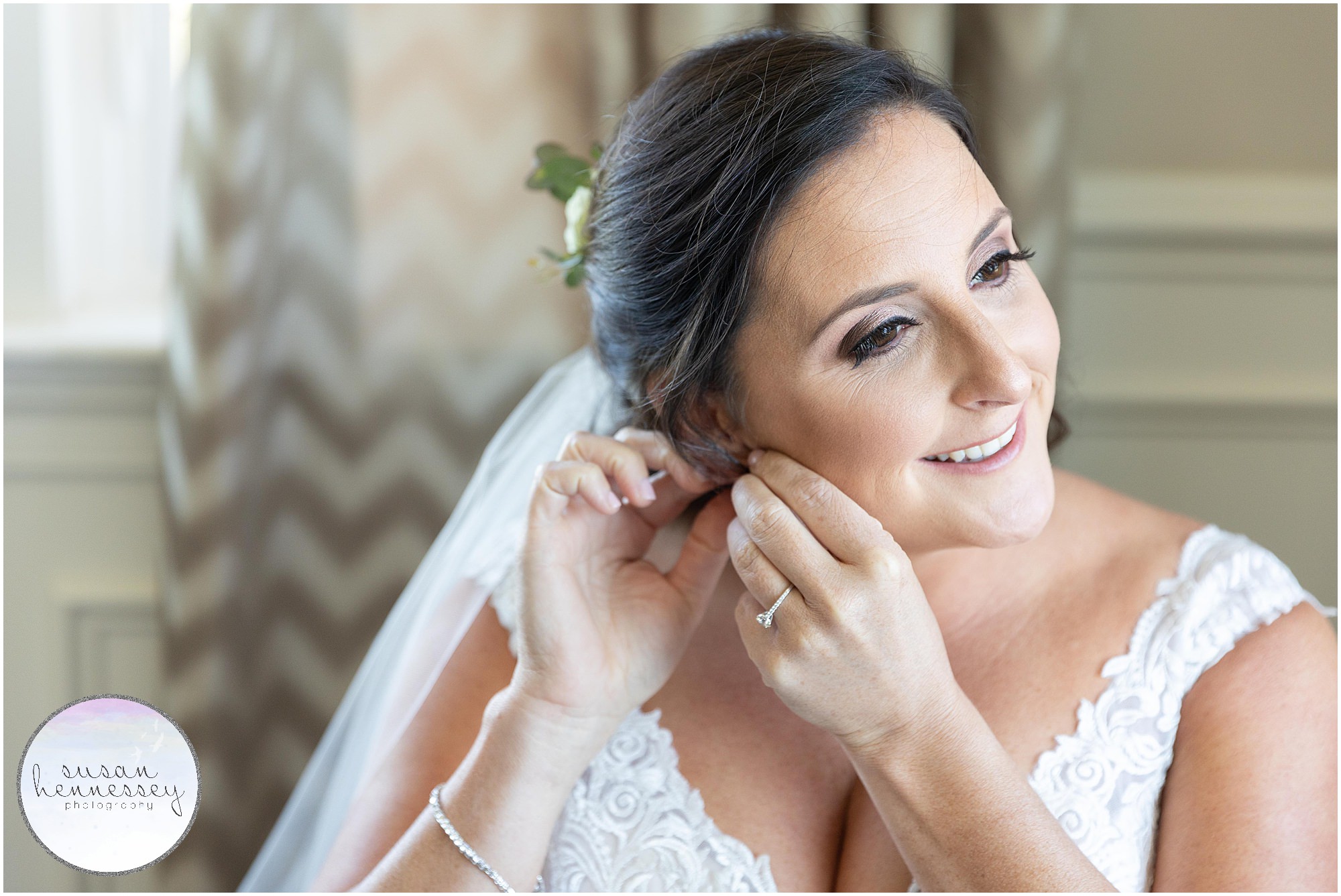 Bride puts on her earrings at Atlantic City Country Club Wedding