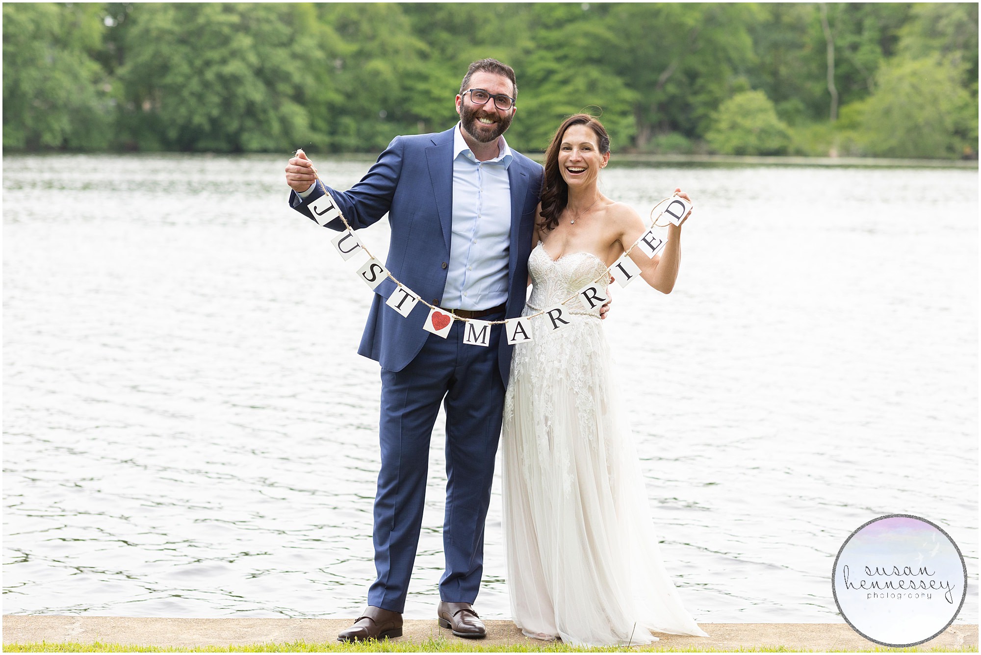 Bride and groom hold just married banner at South Jersey Backyard Wedding
