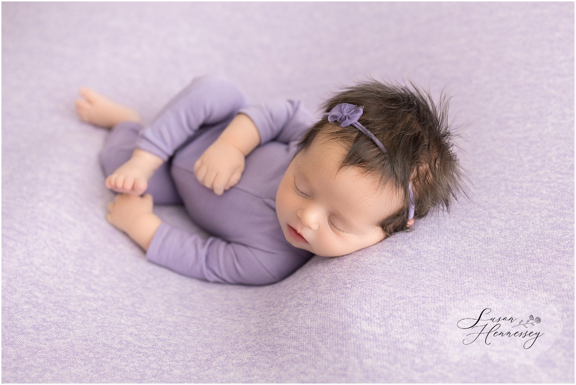 Newborn session with a color palette of purple photographed by South Jersey newborn photographer, Susan Hennessey Photography. 