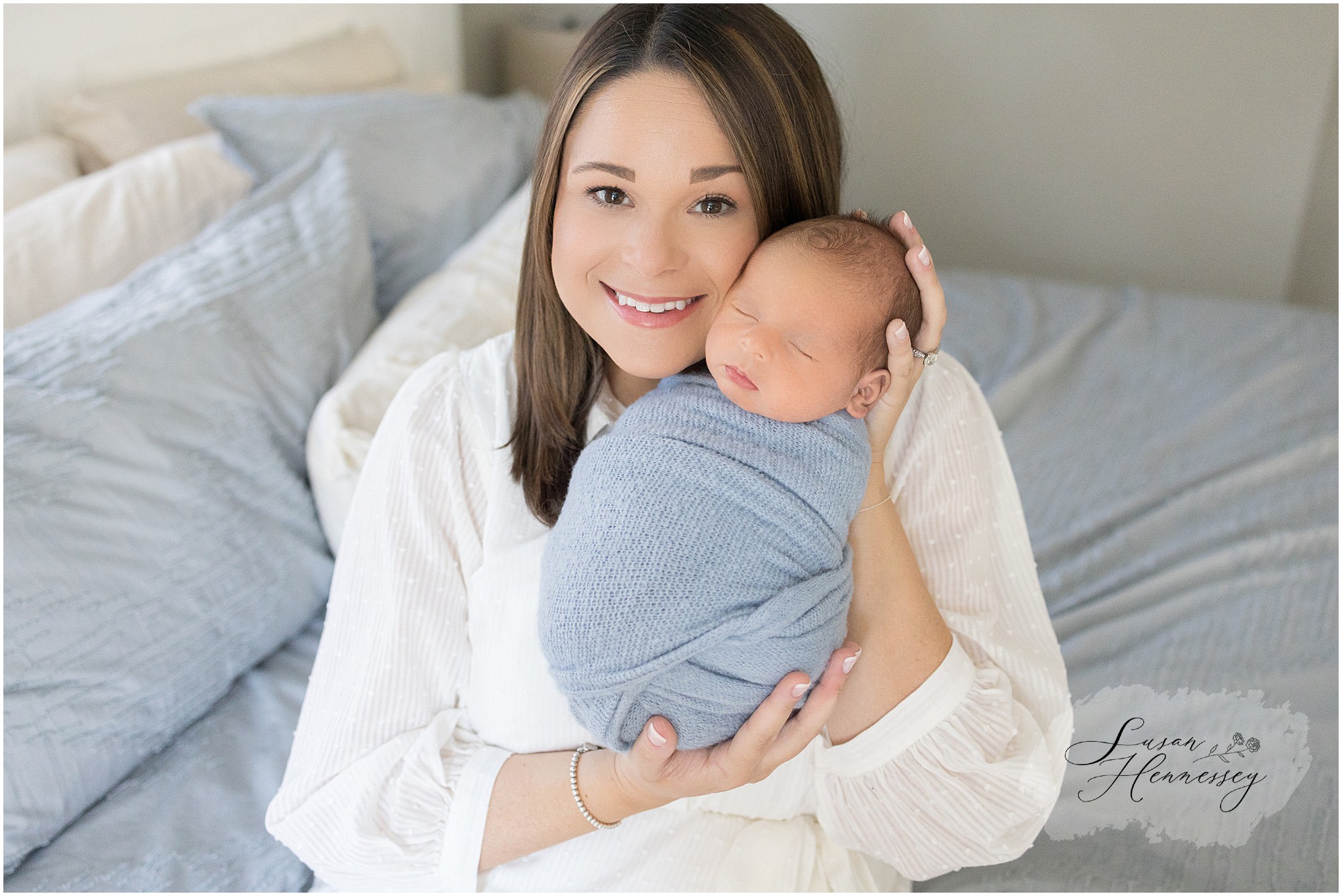 Mother holds newborn baby during newborn session