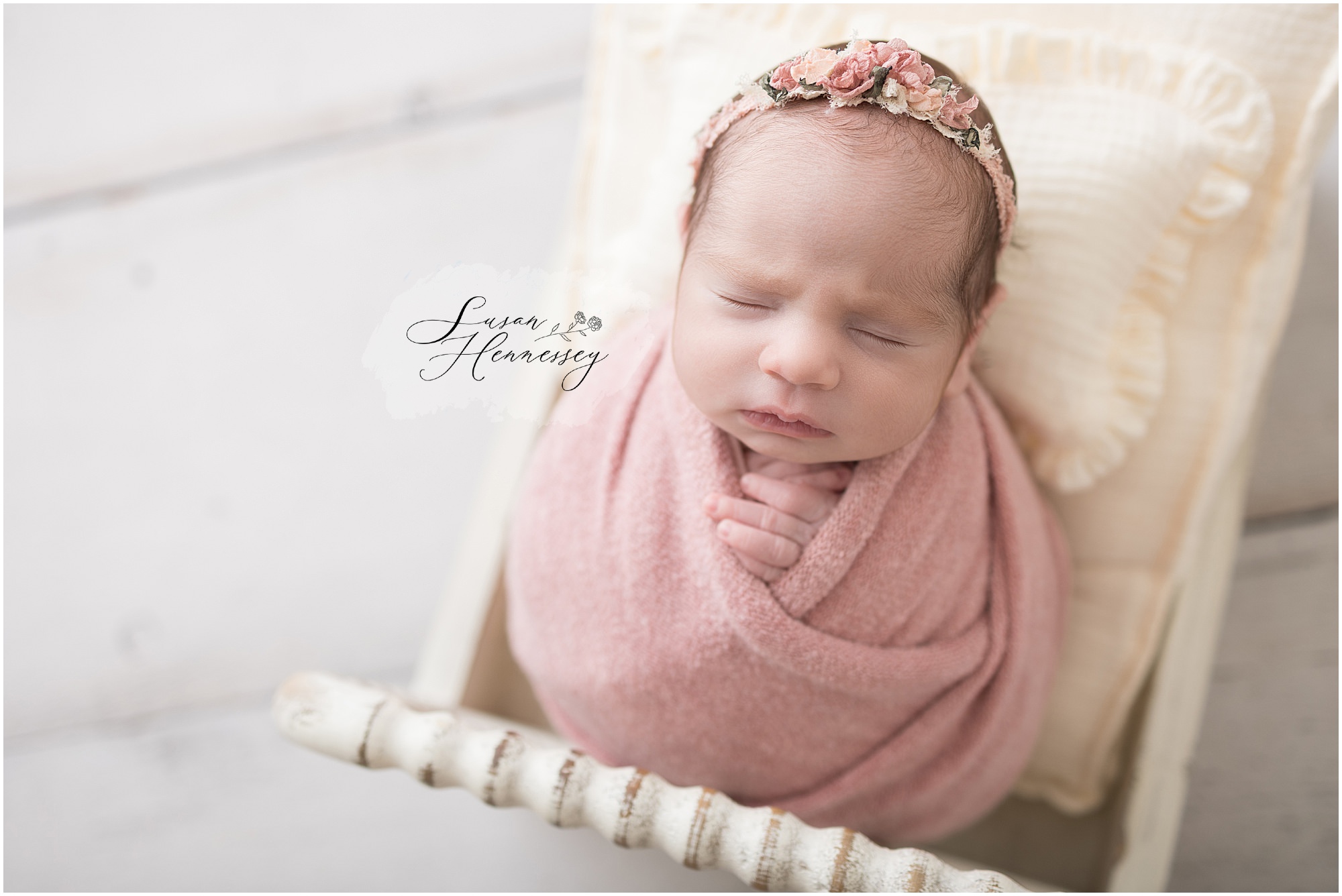 Newborn baby girl Natalie posed in soft pink wraps at South Jersey newborn photography studio