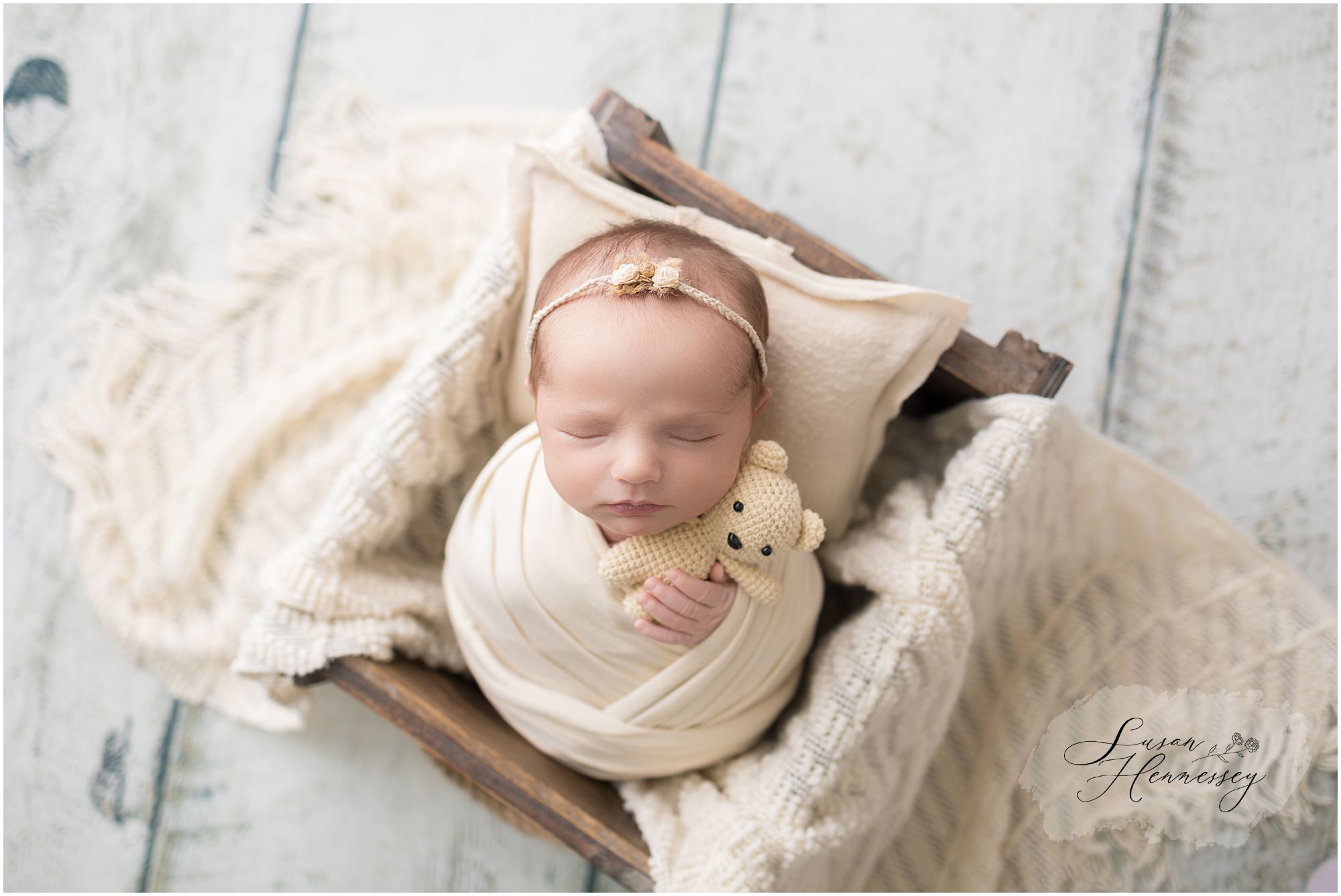 Baby girl newborn portrait wrapped in soft neutral layers at a South Jersey newborn photography studio