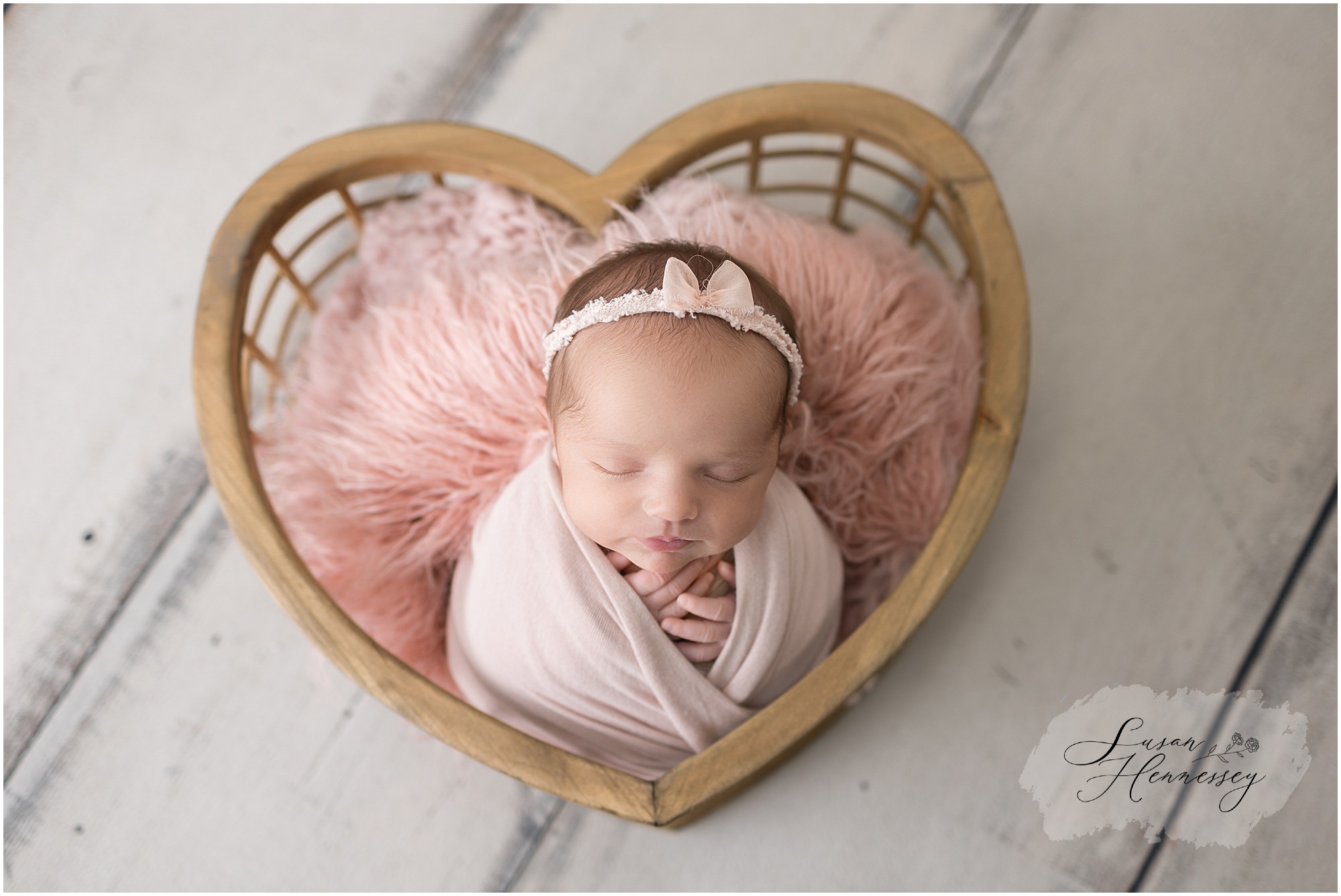 Newborn baby girl wrapped in delicate fabric during her professional South Jersey newborn session
