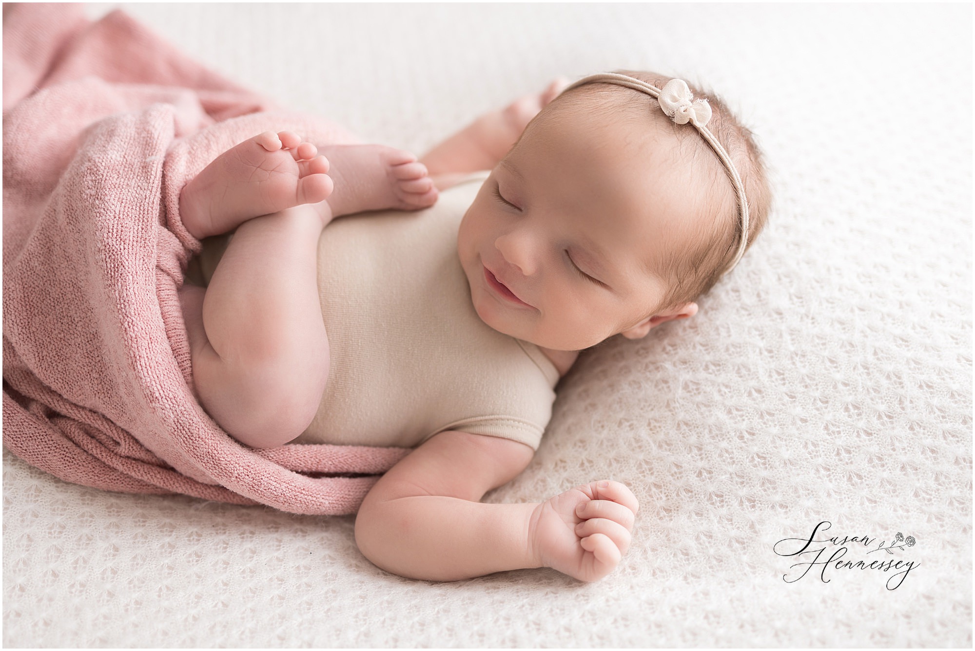 Sleeping newborn baby girl posed on a soft blanket during her South Jersey newborn photography session