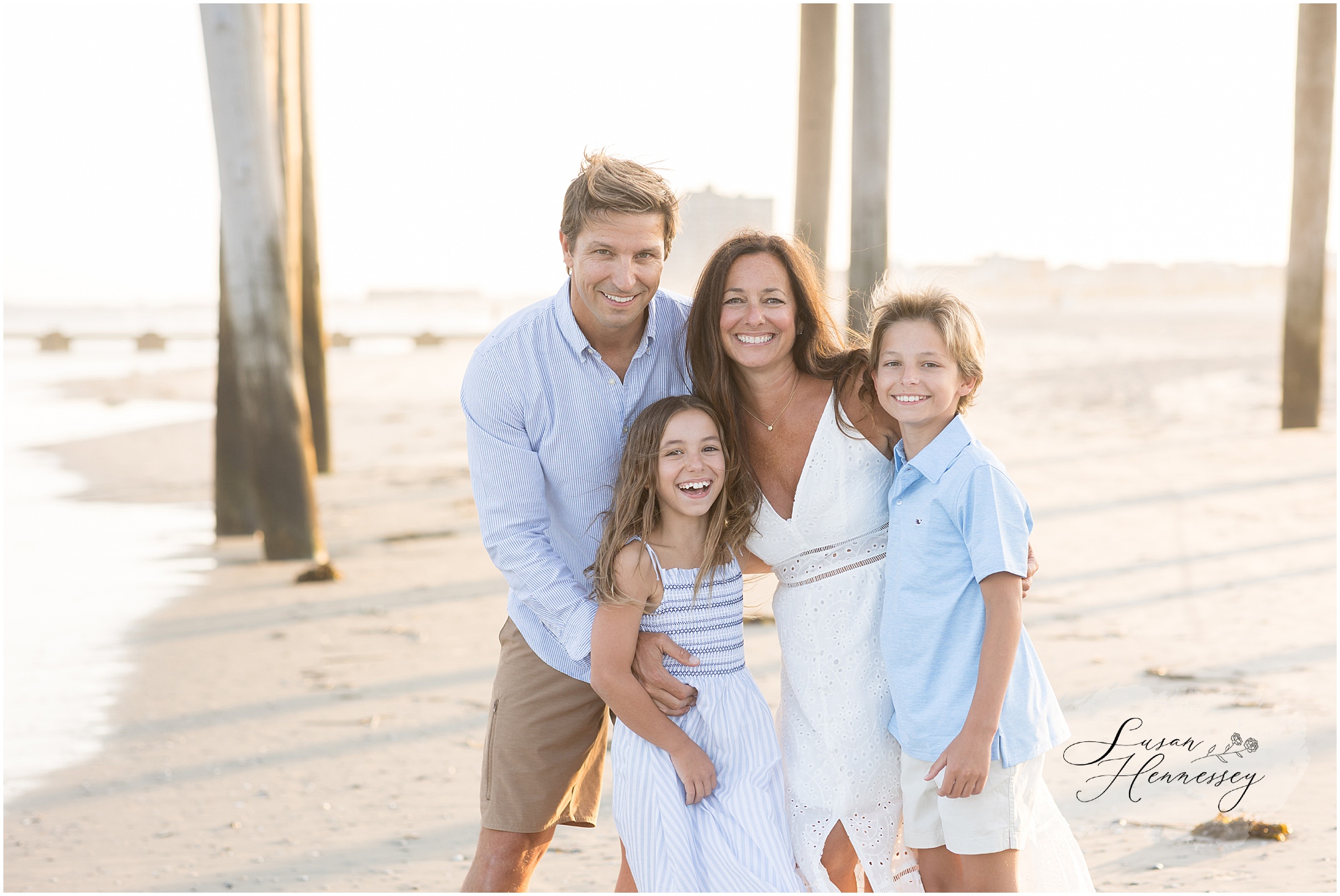 Family hugging on the beach during a Jersey Shore sunset photography session